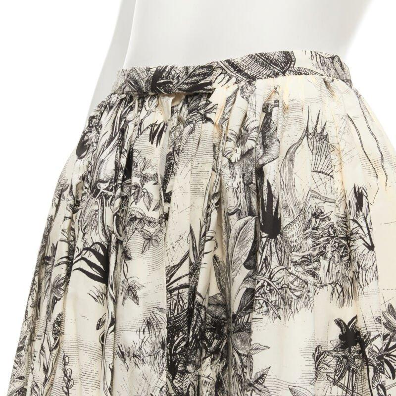 CHRISTIAN DIOR Fantaisie beige illustration print cotton midi skirt FR34 XS
Reference: AAWC/A00008
Brand: Dior
Designer: Maria Grazia Chiuri
Collection: Runway
Material: Cotton
Color: Beige, Black
Pattern: Abstract
Closure: Hook & Eye
Lining: 