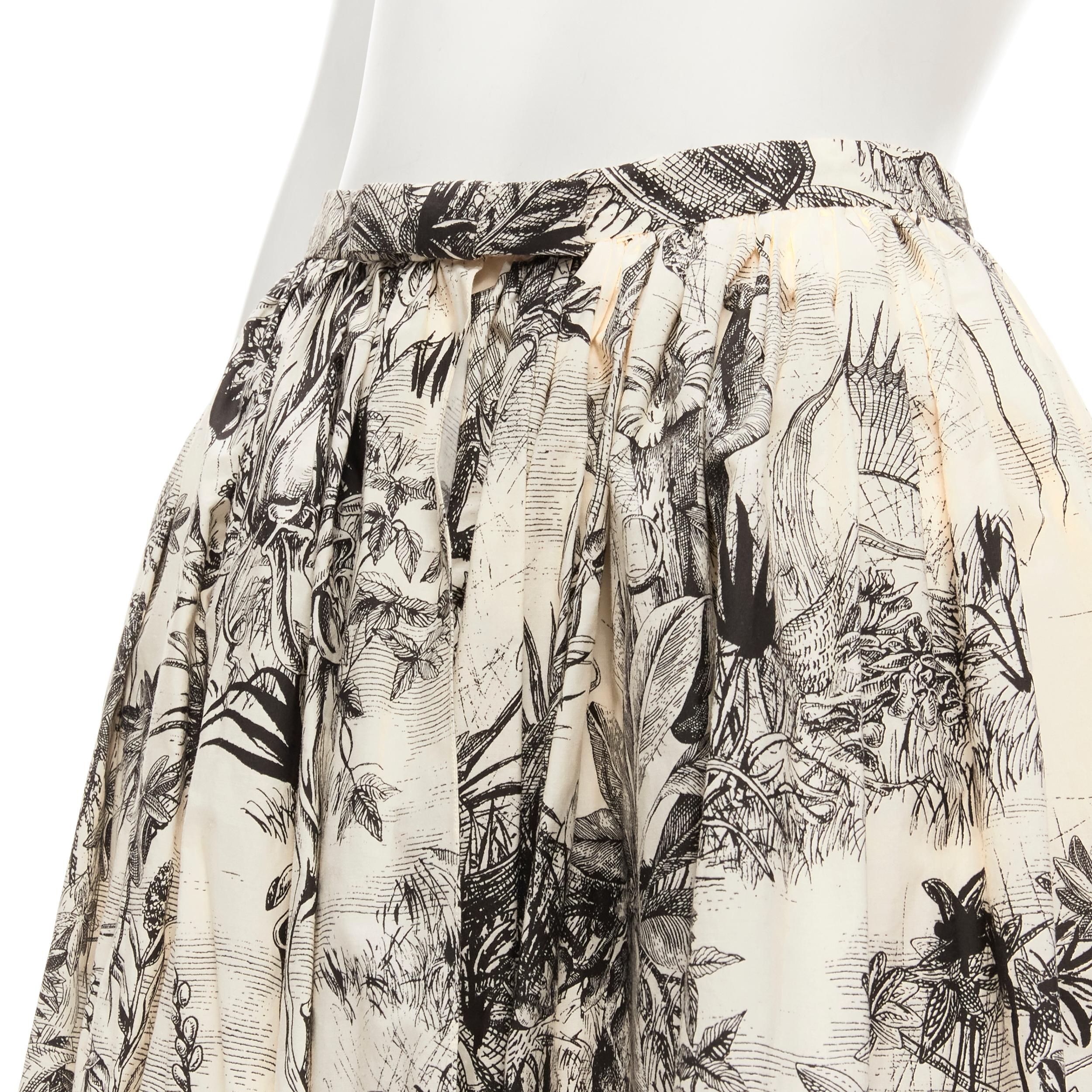 CHRISTIAN DIOR Fantaisie beige illustration print cotton midi skirt FR34 XS
Brand: Christian Dior
Designer: Maria Grazia Chiuri
Material: Cotton
Color: Beige
Pattern: Abstract
Closure: Hook & Eye
Extra Detail: Bow detail at front waist. Open front