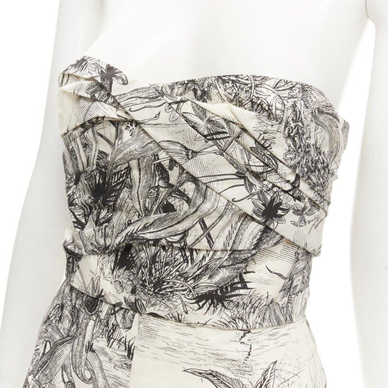 CHRISTIAN DIOR Fantaisie Dioriveria beige black print wrap corset romper FR36 XS
Reference: AAWC/A00072
Brand: Dior
Designer: Maria Grazia Chiuri
Material: Cotton
Color: Beige, Black
Pattern: Abstract
Closure: Zip
Lining:  Unlined
Extra Details:
