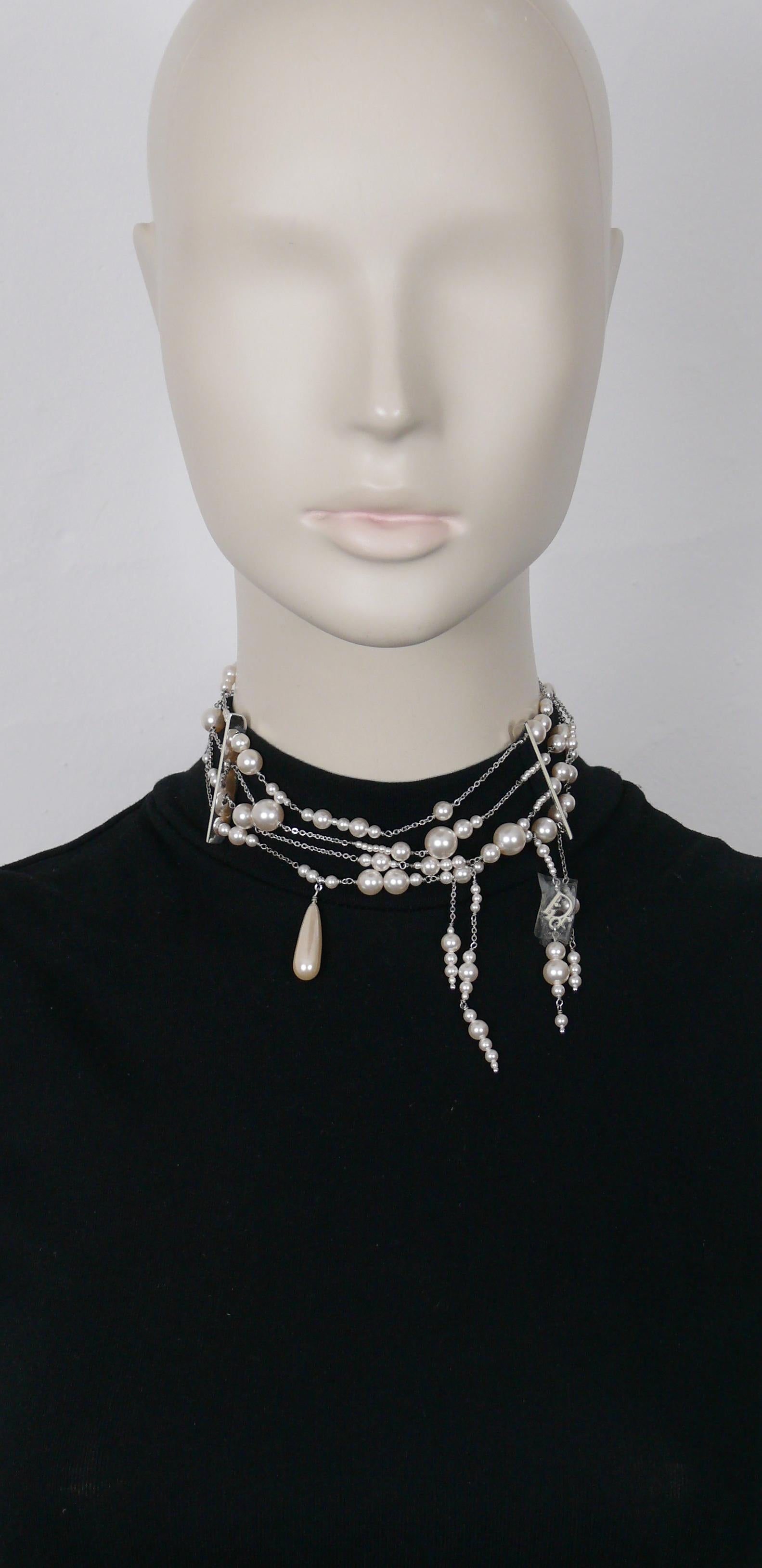 CHRISTIAN DIOR by JOHN GALLIANO choker necklace featuring four rows of chains alterning with graduated faux pearls, cascading faux pearls, drop and DIOR logo charm.

Silver tone metal hardware.

Double hook closure.
Adustable length.

Embossed