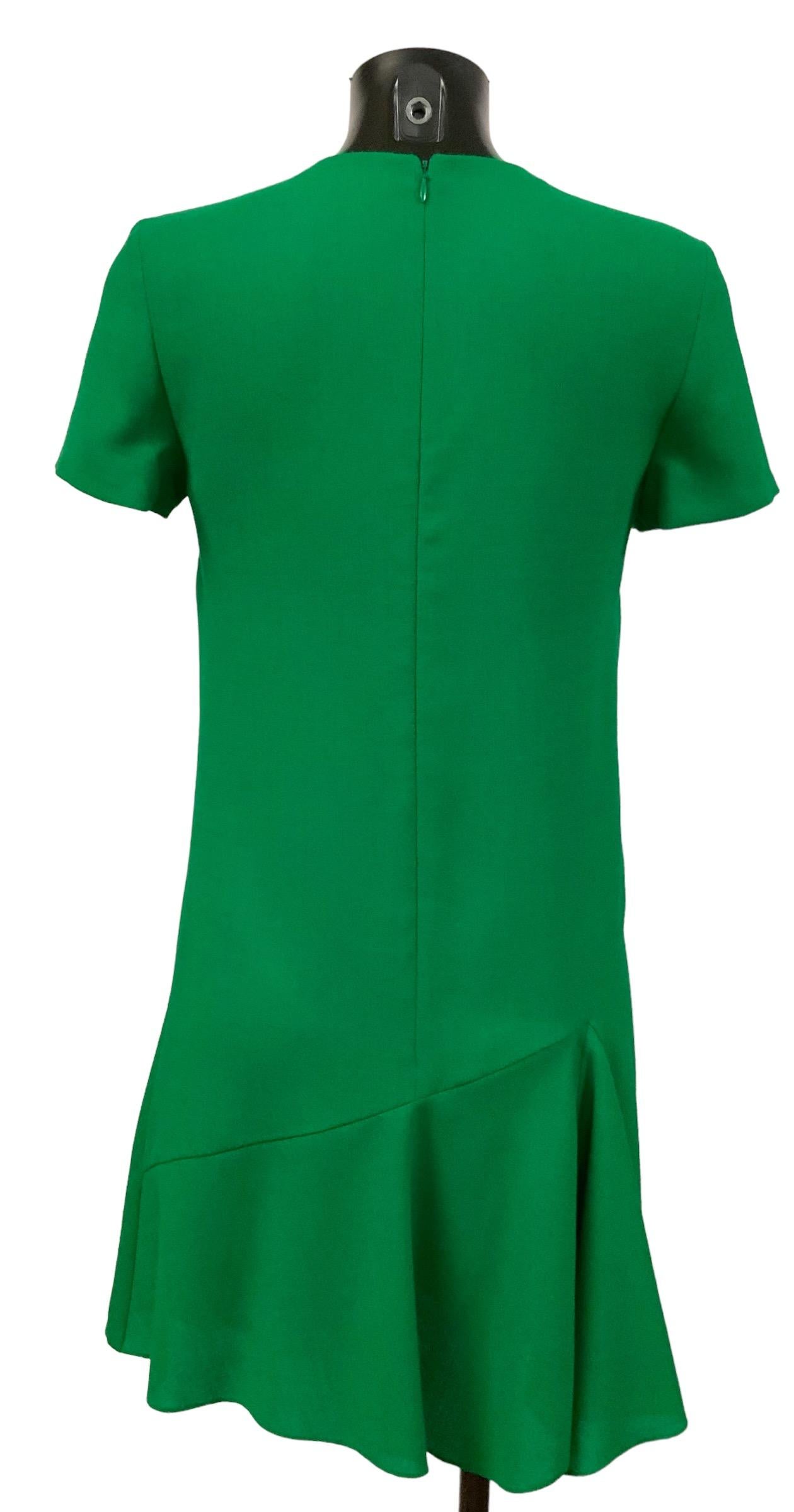 Stunning in its simplicity Chrsitian Dior fit and flare dress with flounces at side. 
It features a hidden back zipper.

Collection: 2000’s
Fabric: 100% wool
Lining: 100% silk
Color: Green
Size: FR 38 
Measurements: Full length: front: 86cm - back: