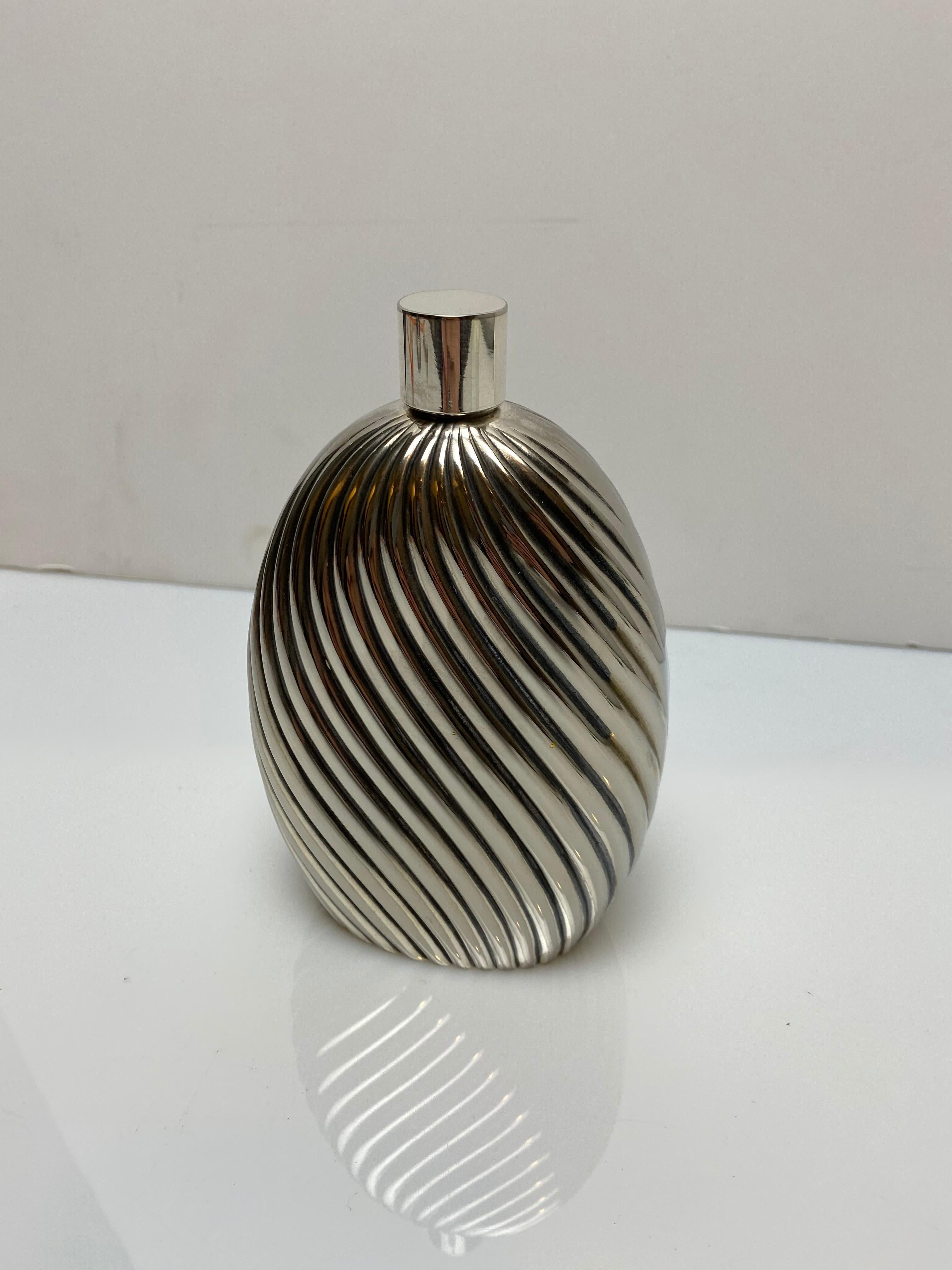 A beautiful fluted flask made by Christian Dior, featuring a screw off cap. Marked on bottom.
