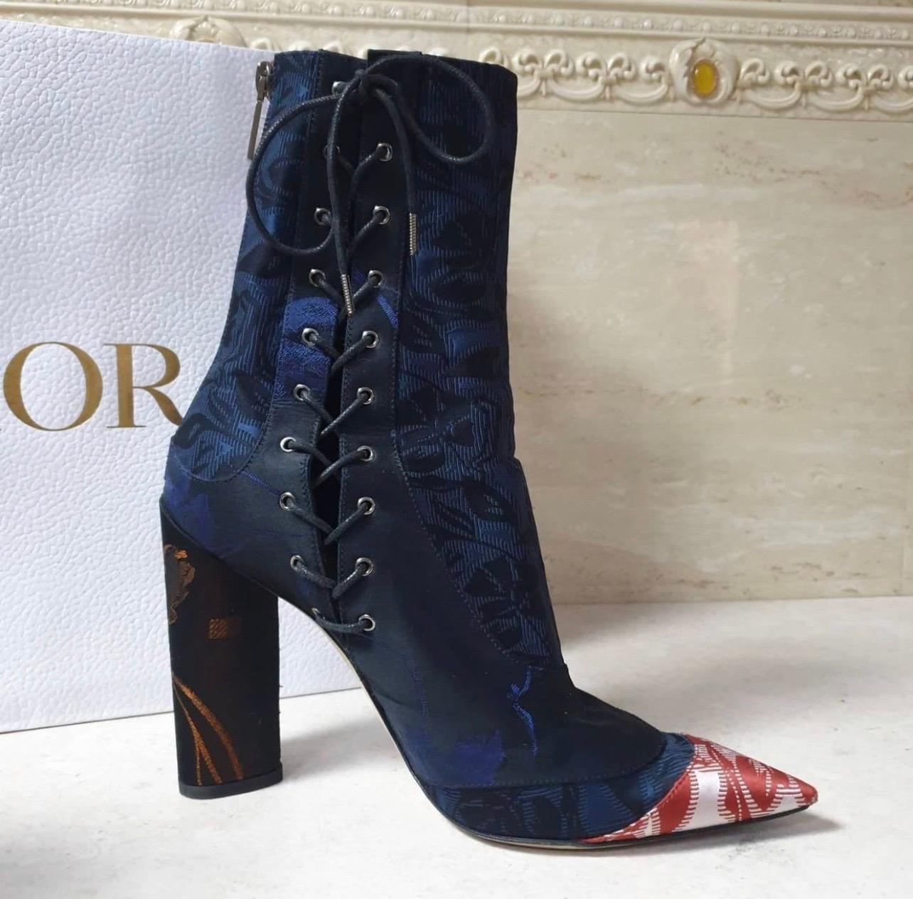 Christian Dior pointed toe ankle boots are nothing but perfect! Blue and Black floral embroidered fabric uppers and a red and white pointed toe, make for a chic look. The sides have lace up closures and a rear zip for easy on and off. Perfect for