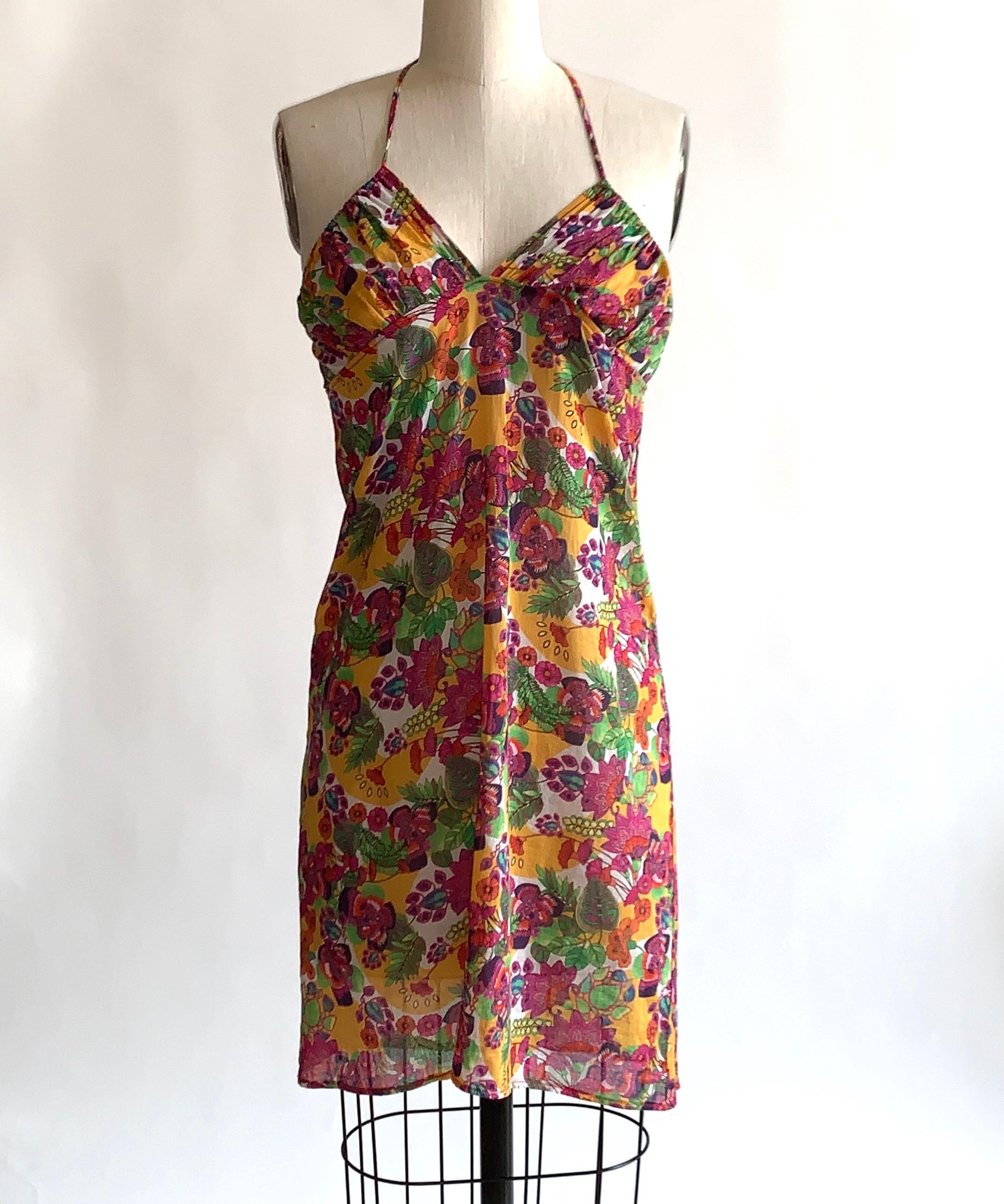 Christian Dior Boutique 2000's golden yellow swim coverup skirt with purple, red and green stylized floral print throughout. Can be worn as drawstring waist skirt or as a halter if you have a smaller neck! The super light cotton makes this perfect