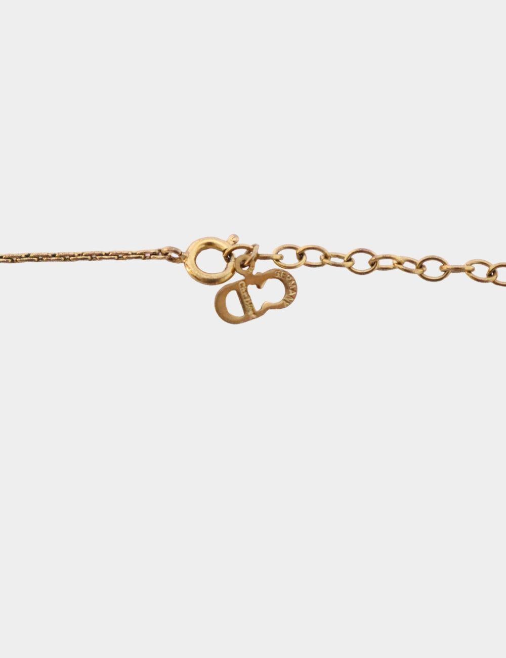 Add a touch of refined luxury to your jewelry collection with this Christian Dior Vintage Crystal CD Logo Necklace. This delicate piece features a fine gold-tone chain accented by a signature 'CD' logo pendant adorned with a sparkling crystal