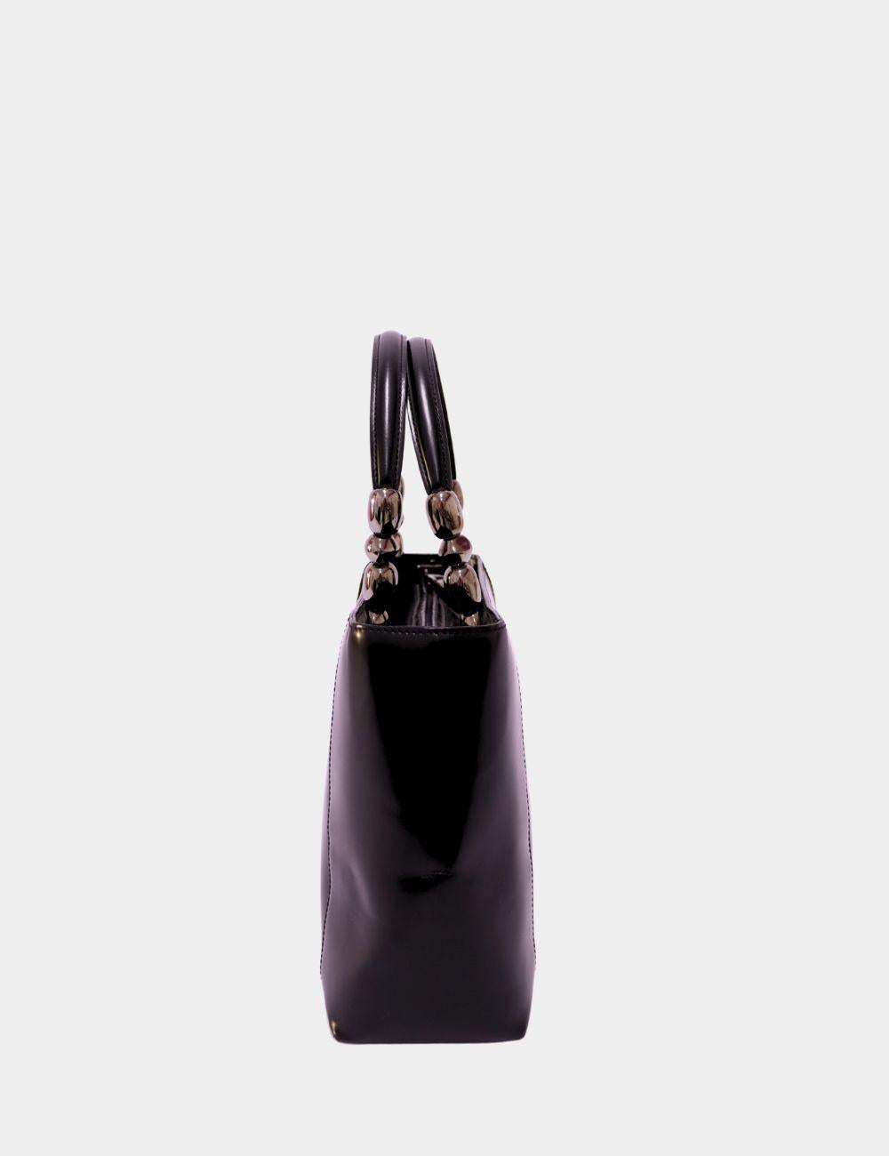 Sleek, structured, and timelessly elegant, this Christian Dior black leather tote bag is a refined addition to your designer collection. Crafted in smooth, high-quality leather, it features a structured silhouette with dual top handles adorned with