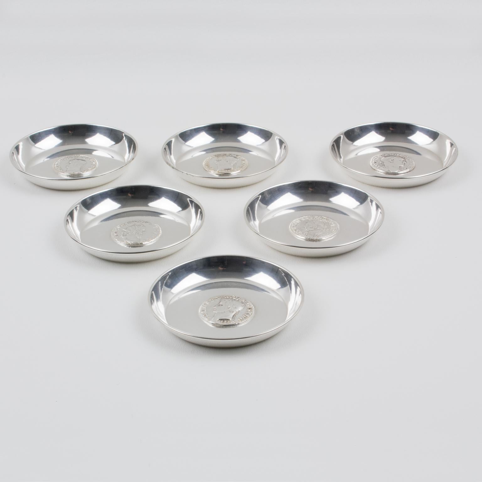 Handsome barware accessories, a set of six wine or cocktail coasters, made by Christian Dior, France for his Home Collection. Minimalist rounded shape in silver plate metal with antique coins embossed design in the center. Each coaster has a