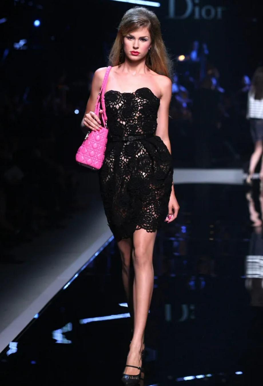 From John Galliano’s Resort 2011 collection for Christian Dior, this exquisite lace dress channels the opulence and romance that defined his storied tenure at the house. Crafted from intricate black guipure lace, it features a delicate rose motif