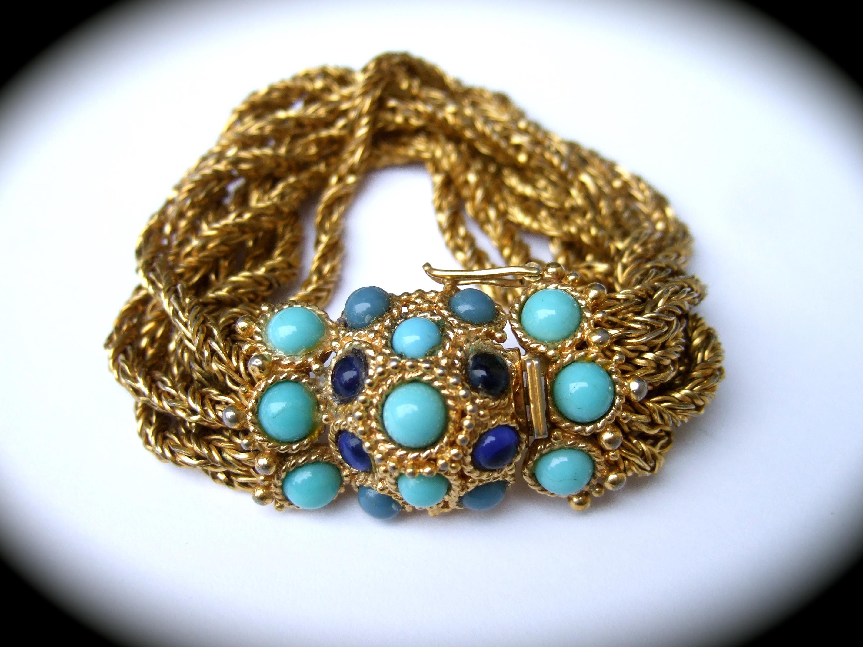 CHRISTIAN DIOR Rare glass cabochon mesh chain bracelet c 1967
The vintage designed bracelet is designed with a cluster of glass
cabochons encrusted on the clasp 

The glass cabochons are three shades of blue, turquoise, lapis & aqua
color glass. The