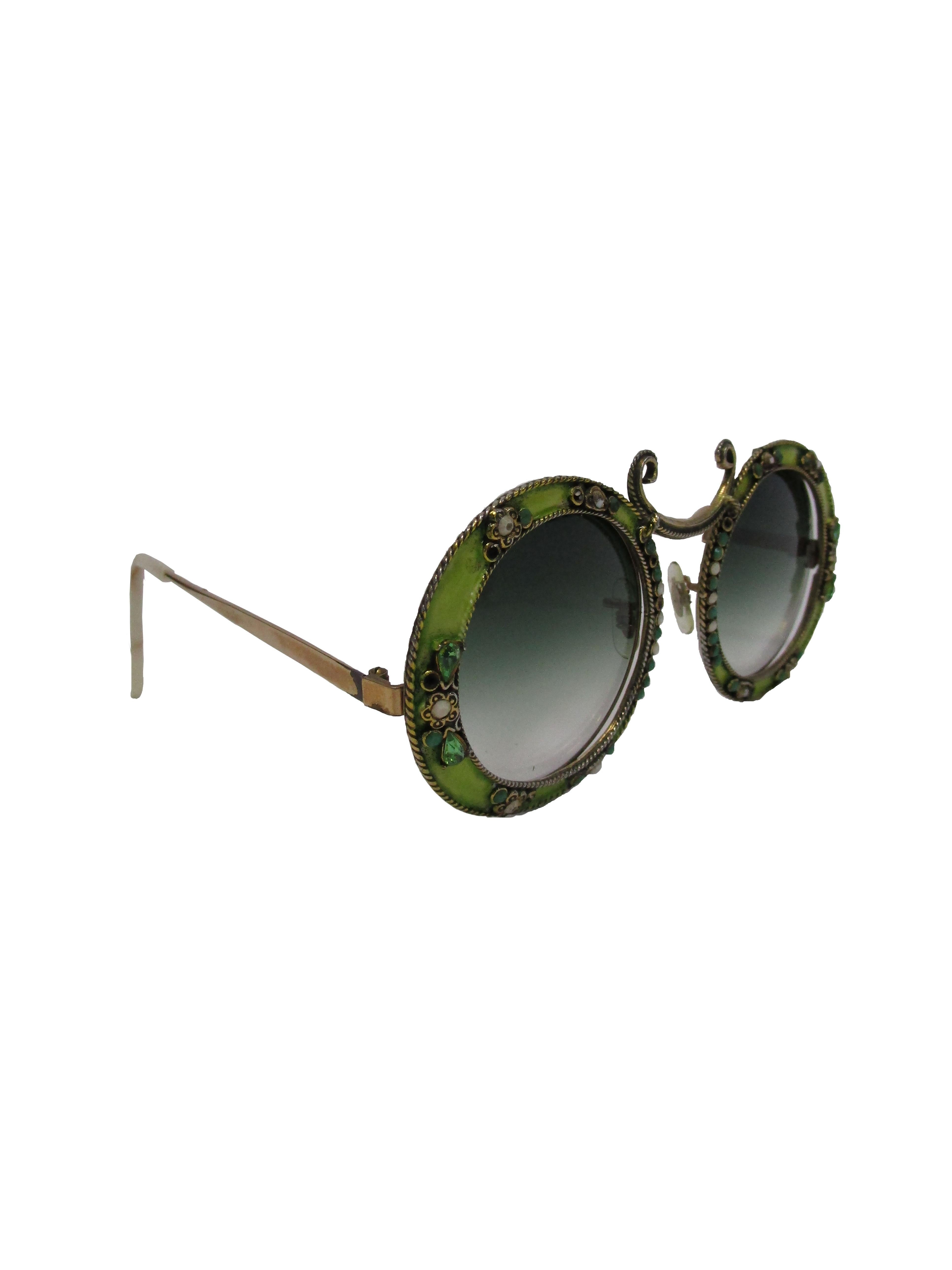 
Lovely, whimsical, and absolutely charming! These bright and breezy sunglasses feature a green enamel over a 1/10 12 KGF frame. The frame is encrusted with round and pear shaped rhinestones in grassy greens and white, sitting between floral