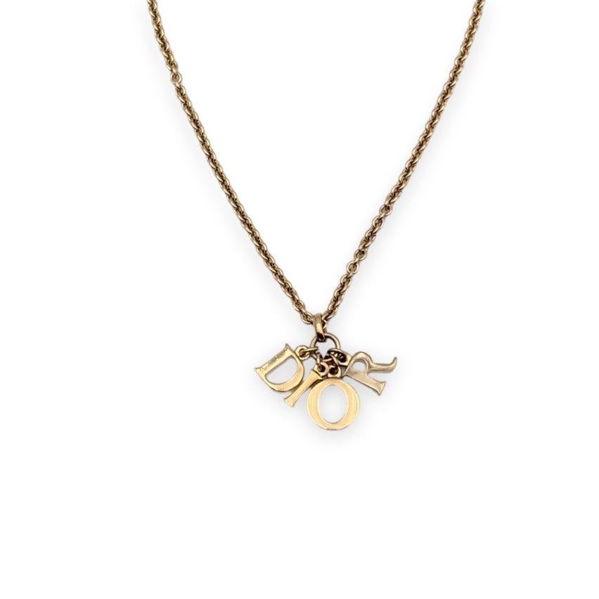 Christian Dior gold metal necklace. Dangling D.I.O.R. letter charms in the center. Lobster closure. Chain length: about 18 inches - 7.10 cm Condition A - EXCELLENT Gently used. Please, look carefully at the photos and ask for any detail. Details