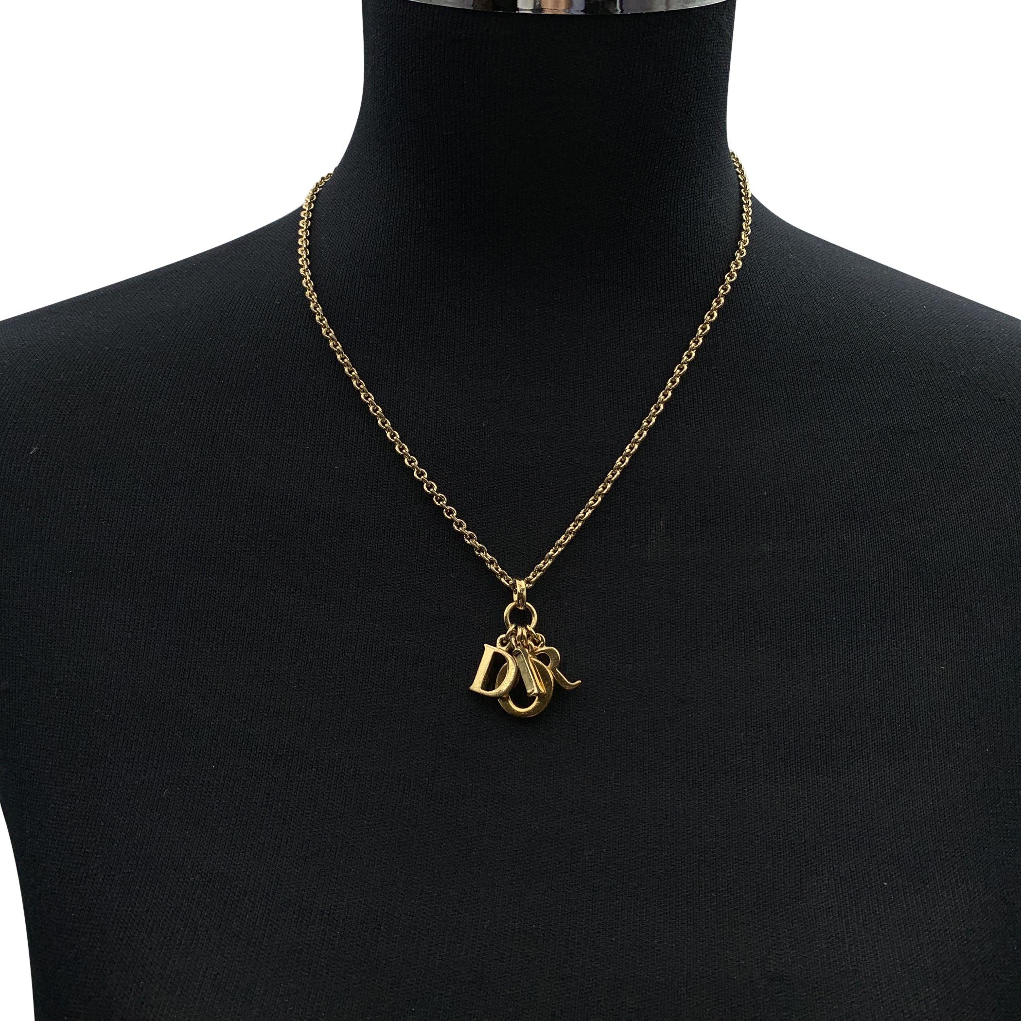 Christian Dior gold metal necklace. Dangling D.I.O.R. letter charms in the center. Lobster closure. Chain length: about 17.5 inches - 44.5 cm Condition B - VERY GOOD Gently used. Light darkness on metal. Please, look carefully at the photos and ask