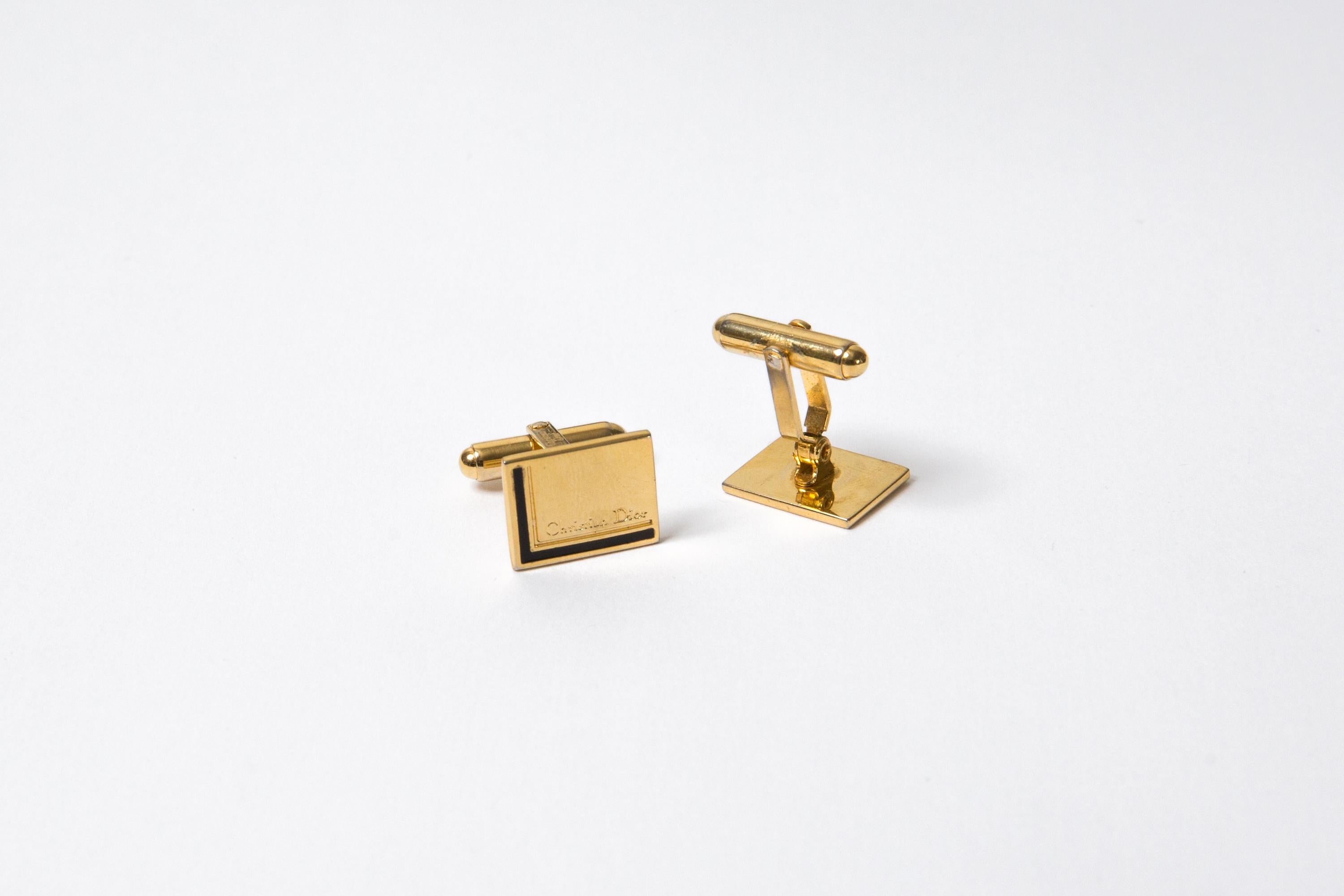 Christian Dior Gold-tone and black cufflinks featuring a rectangular shape,  Christian Dior pitted a black corner line. They come as a pair. 
Circa 1990s 
Made in France In good vintage condition   
0.6in (1.5cm) X 0.39in (1cm)
Maxi Length:  0.8in