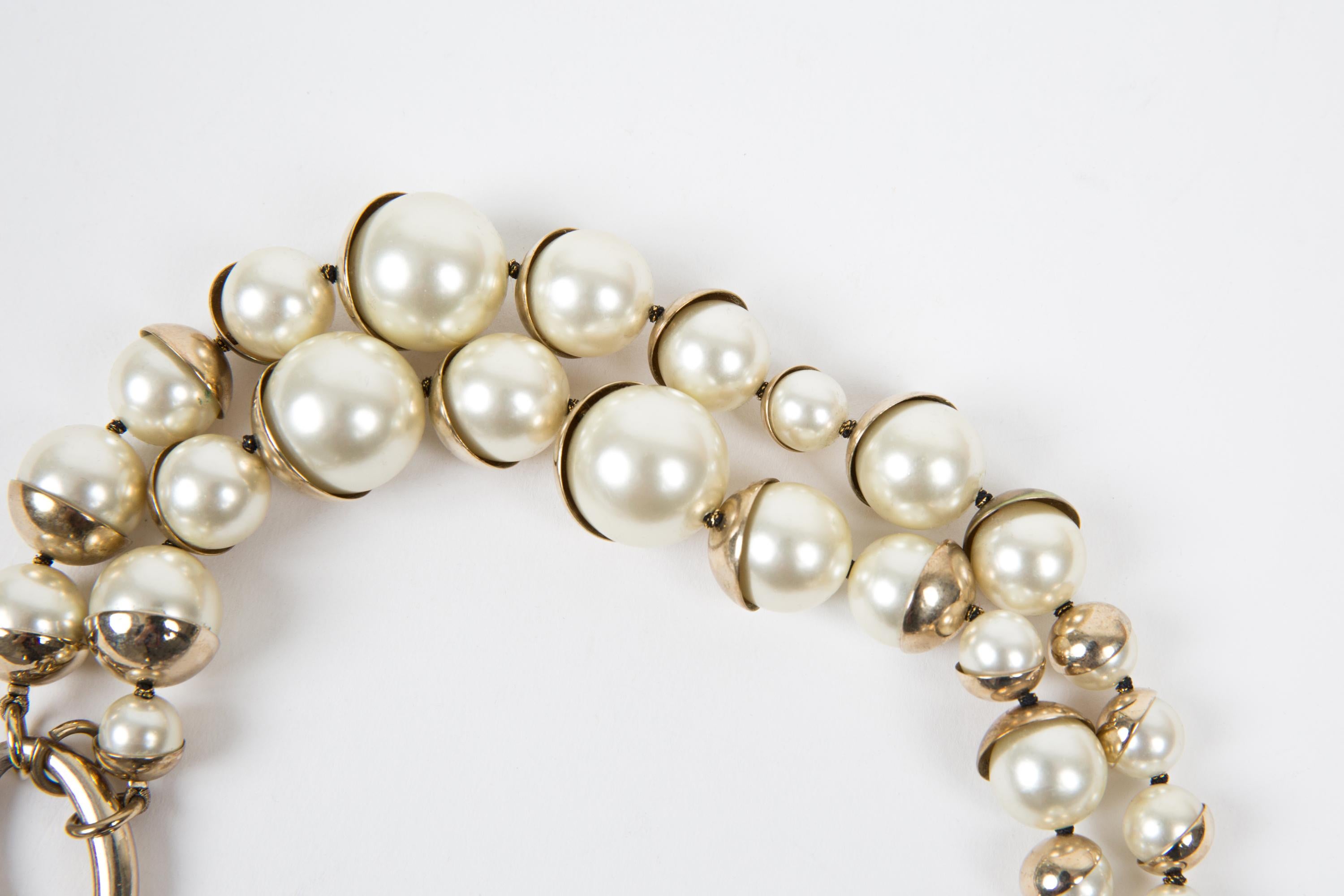 Christian Dior Ivory faux pearls & Gold-tone necklace by John Galliano featuring 2 raw faux-pearls with tarnish gold-tone cups, a logo CD fastening.   
Length: 18.50in. (47cm)
Circa: 1990s
In good vintage condition. Made in France.
We guarantee you