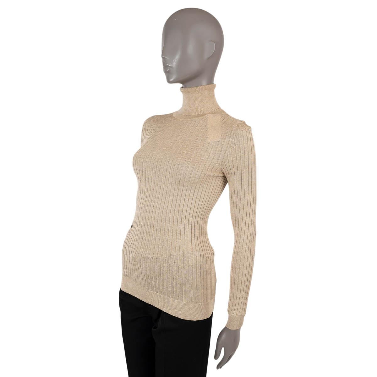 100% authentic Christian Dior rib-knit turtleneck sweater in beige viscose (80%) and metallic gold lurex polyester (20%) featuring black embroidered bee emblem. Has been worn and is in virtually new condition.

2019