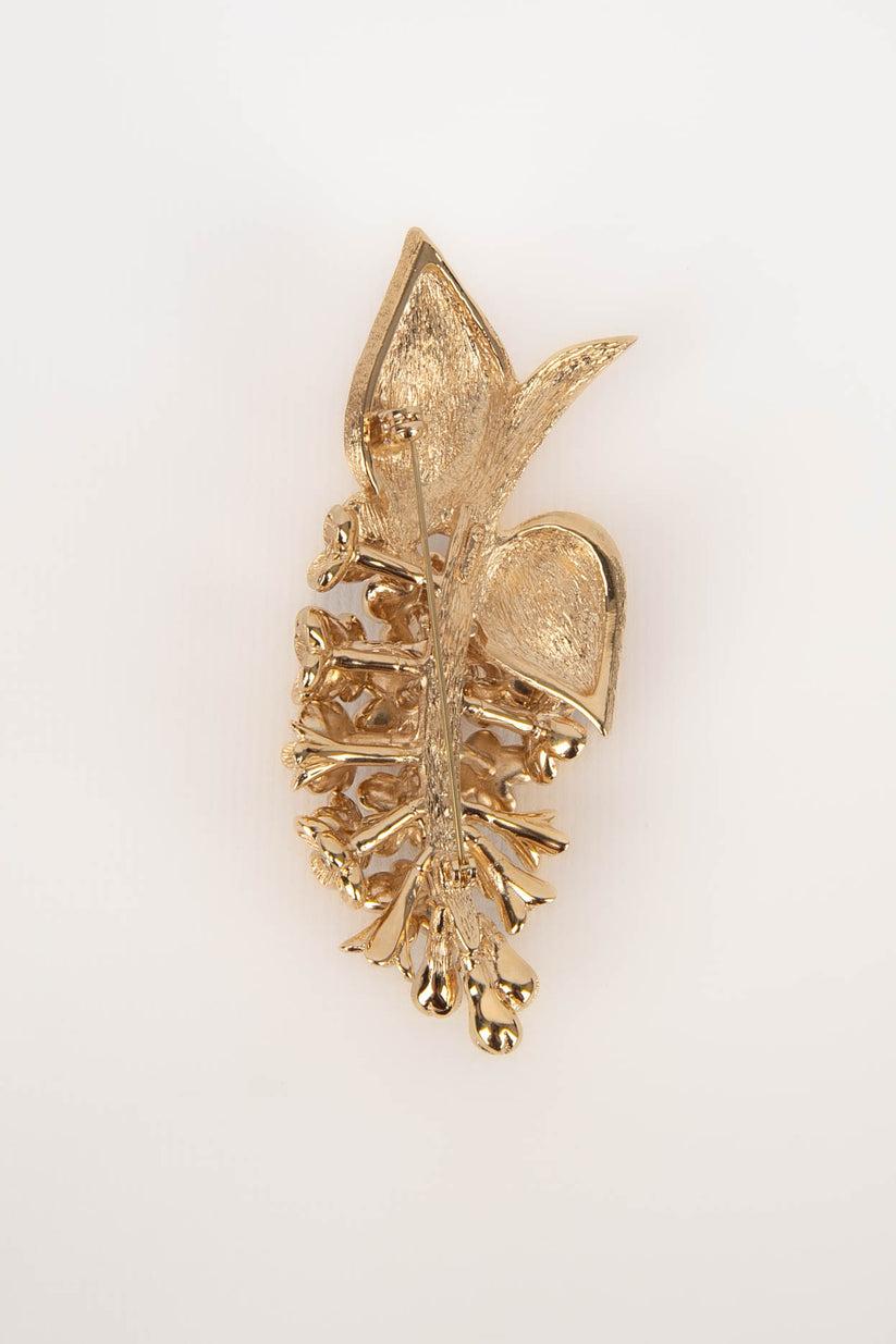 Dior - Broche en métal doré avec strass.

Informations complémentaires :
Condit : Très bon état.
Dimensions : Longueur : 9 cm

Référence du vendeur : BR1