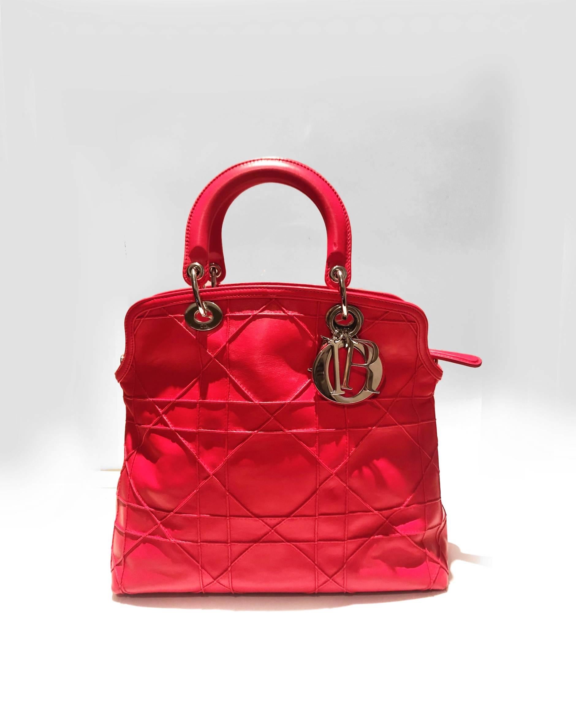 Christian Dior Granville Dior calfskin leather tote bag in strawberry red with Cannage stitching, double internal compartments, buttoned and zipped, double handles, interior zip and patch pockets, tonal metal 'D.I.O.R.' charms. can be carried by