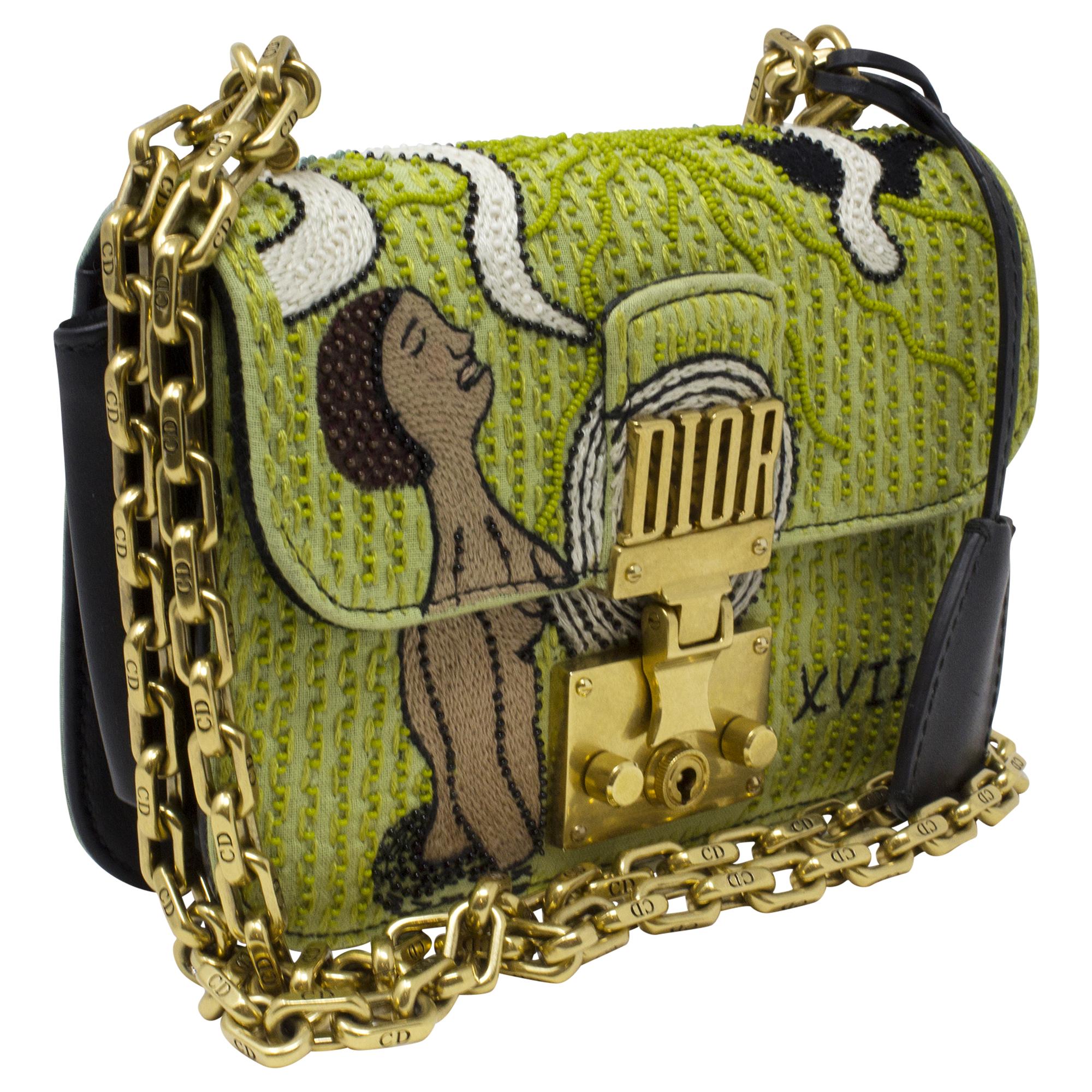 Introducing the Christian Dior Green Beaded Dioraddict Flap Bag, a striking accessory for the modern fashionista. Crafted from luxurious green fabric, this bag is adorned with intricate beadwork, adding an elegant touch to any ensemble. With its