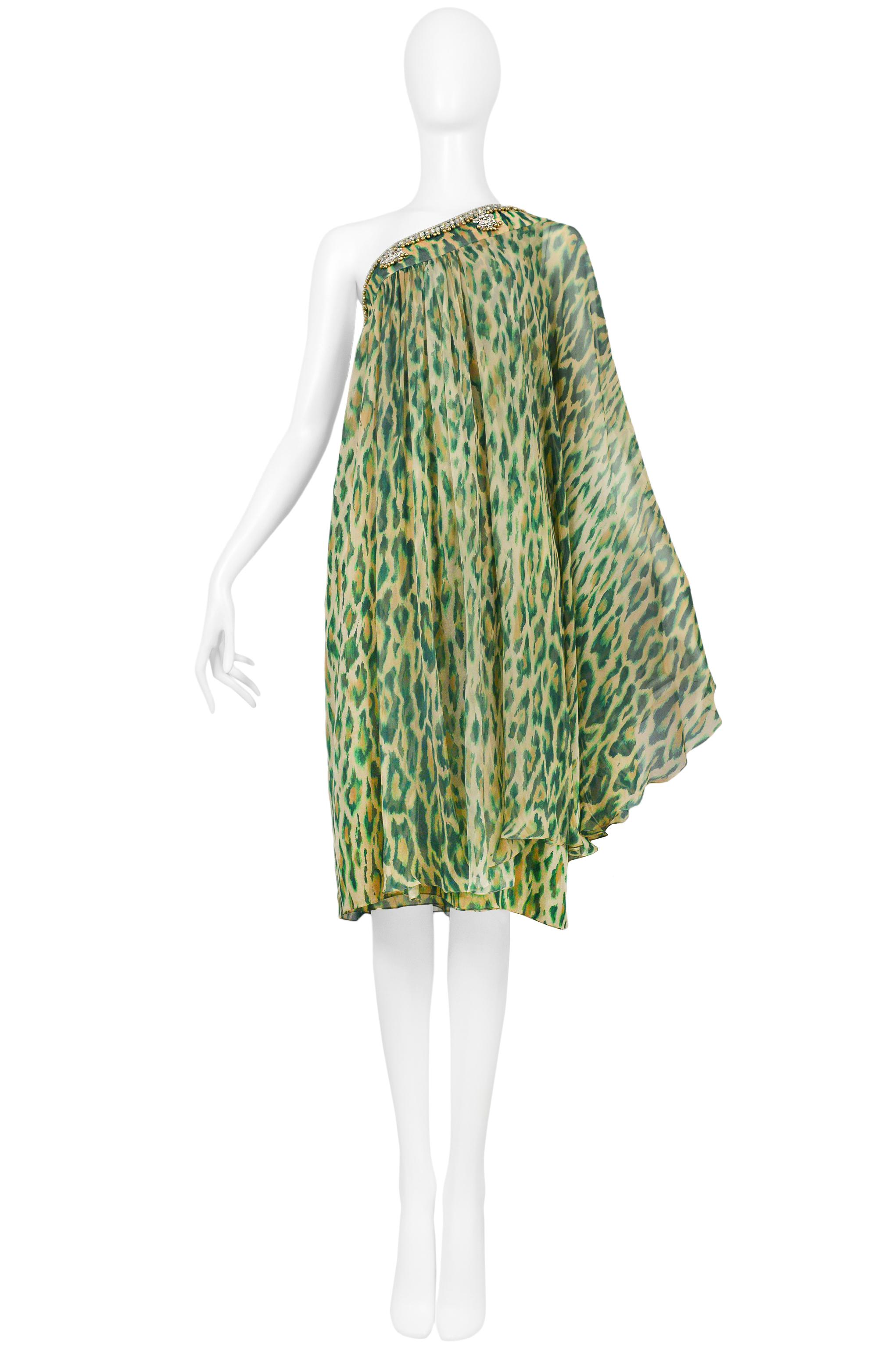 Resurrection is excited to offer a vintage Christian Dior green dress featuring, a leopard print, rhinestones along the top of the dress, a chiffon shoulder overlay, and button closure on the side seam.

Christian Dior Paris
Size 42
100% Silk
2008