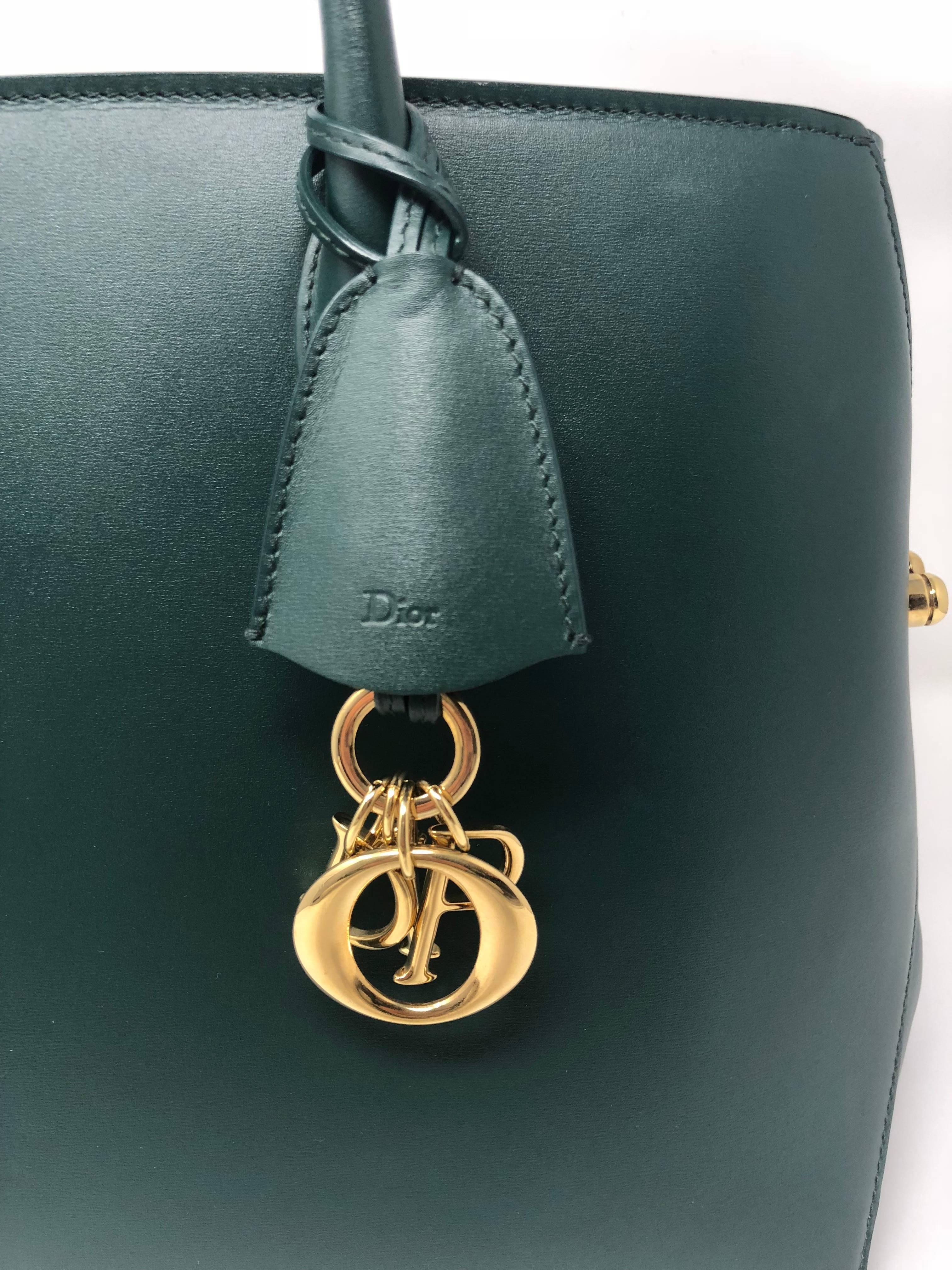 Christian Dior Green Open Bar Tote Bag with gold hardware. Small pen mark in the front near the left side of the handle. Otherwise in great condition. 