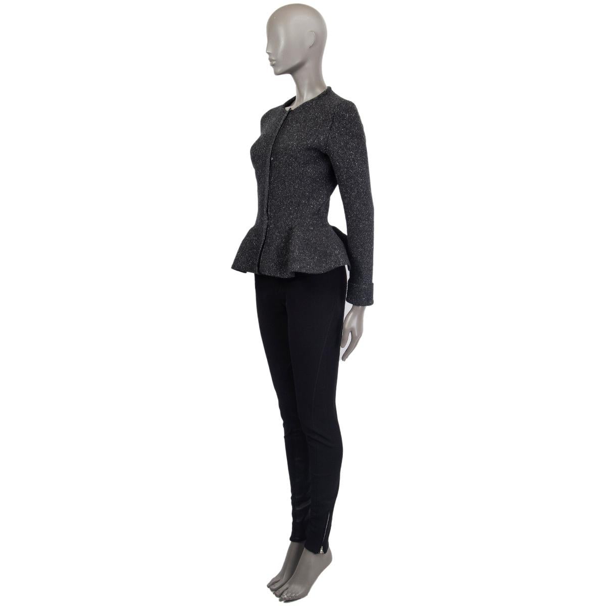 Christian Dior collarless peplum lurex knit jacket in dark grey cashmere (70%), viscose (17%), polyamide (12%) and elastane (1%) with silver lurex thread. Closes with a hidden gold-tone zipper on the front. Unlined. Has been worn and is in excellent