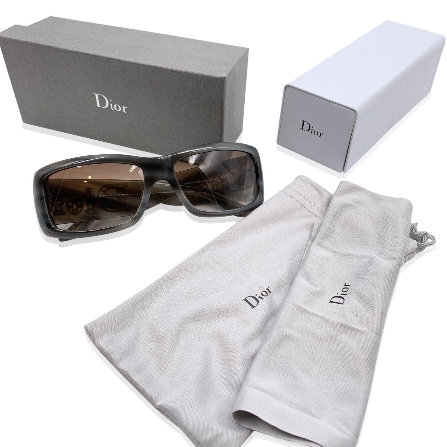 CHRISTIAN DIOR Aventura 2 Sunglasses,2W85M. Size 56/17 135mm. Grey acetate frame, sides with large silver metal Dior logos. 100% Total UVA/UVB protection gradient light brown lenses. Made in Italy. Details MATERIAL: Plastic COLOR: Grey MODEL: Dior