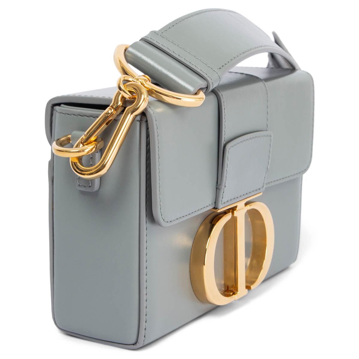 100% authentic Christian Dior 30 Montaigne Box crossbody bag in gray smooth box calfskin. The flap has an antique gold-finish metal 'CD' clasp, inspired by the seal of a Christian Dior perfume bottle. Embossed '30 MONTAIGNE' signature at the back.
