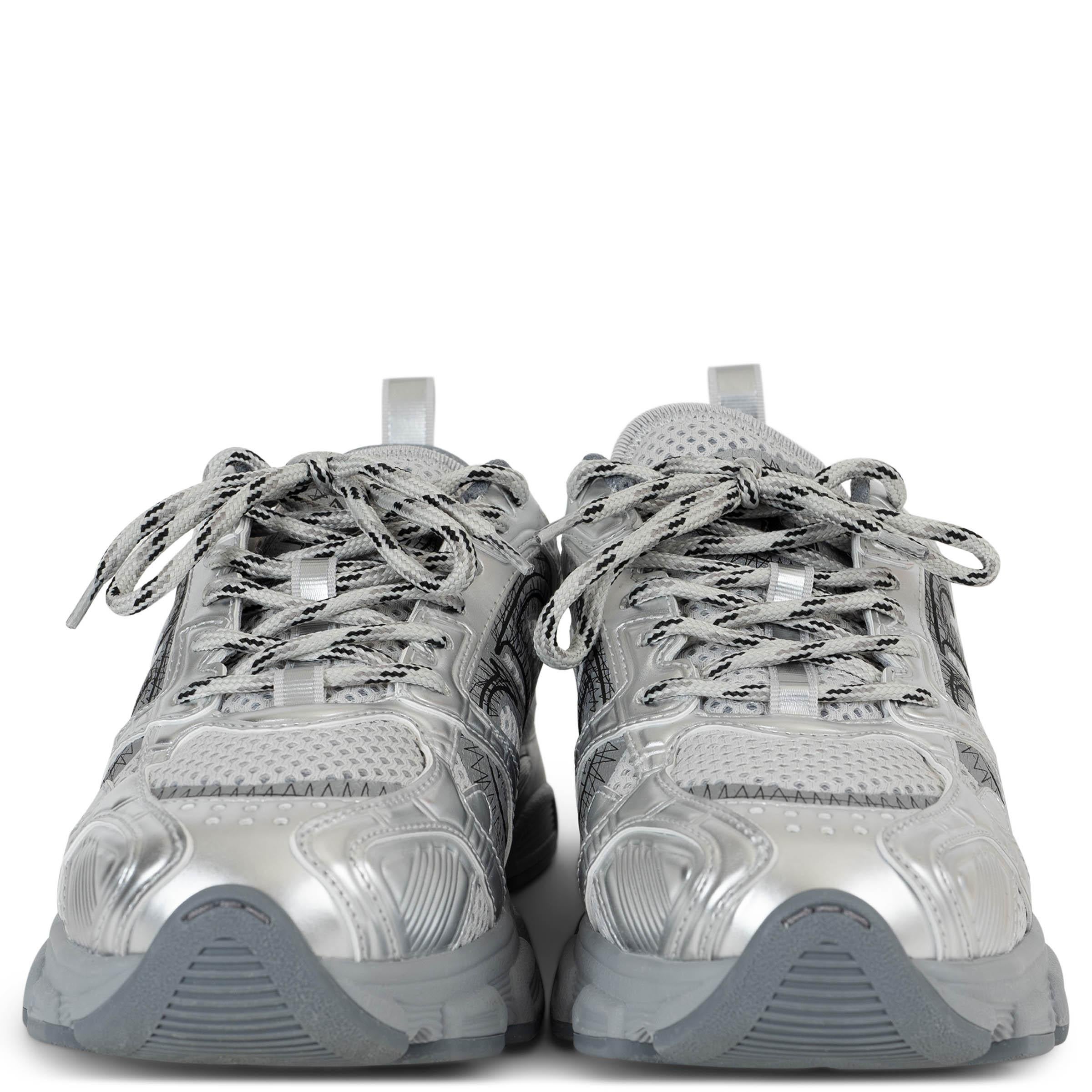 This 100% authentic Christian Dior Chrono sneakers in grey mesh blend sporty innovation with refined detailing. Accented with silver laminated leather trims, they feature rounded toes for a sleek silhouette. The CD logo on the outsides, black