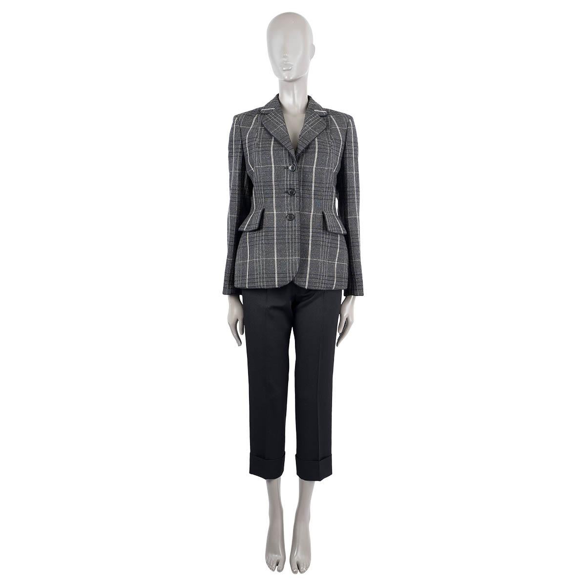 100% authentic Christian Dior blazer in grey wool (100%) with ivory and black plaid print. Features a peak collar and two flap pockets on the front. Closes with buttons on the front and is lined in silk (100%). Brand new with tags.

2018