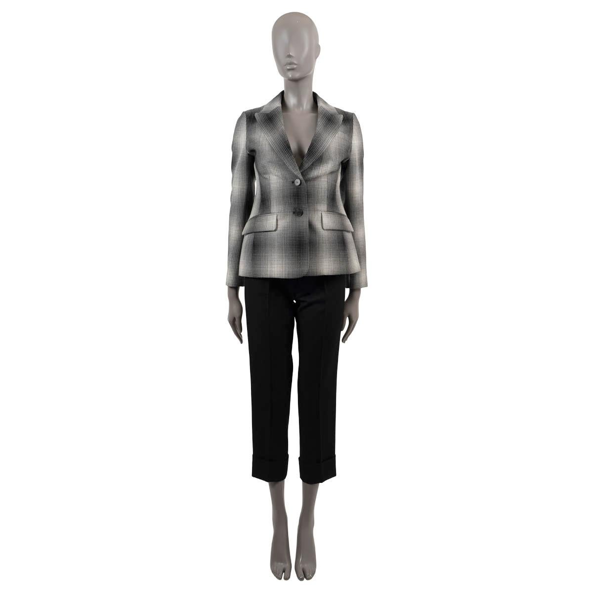 100% authentic Christian Dior gradient plaid blazer in black, grey and cream wool (100%). Features a tailored silhouette, peak lapels and two flap pockets at the waist. Closes with two horn buttons. Lined in silk (100%). Has been worn and is in
