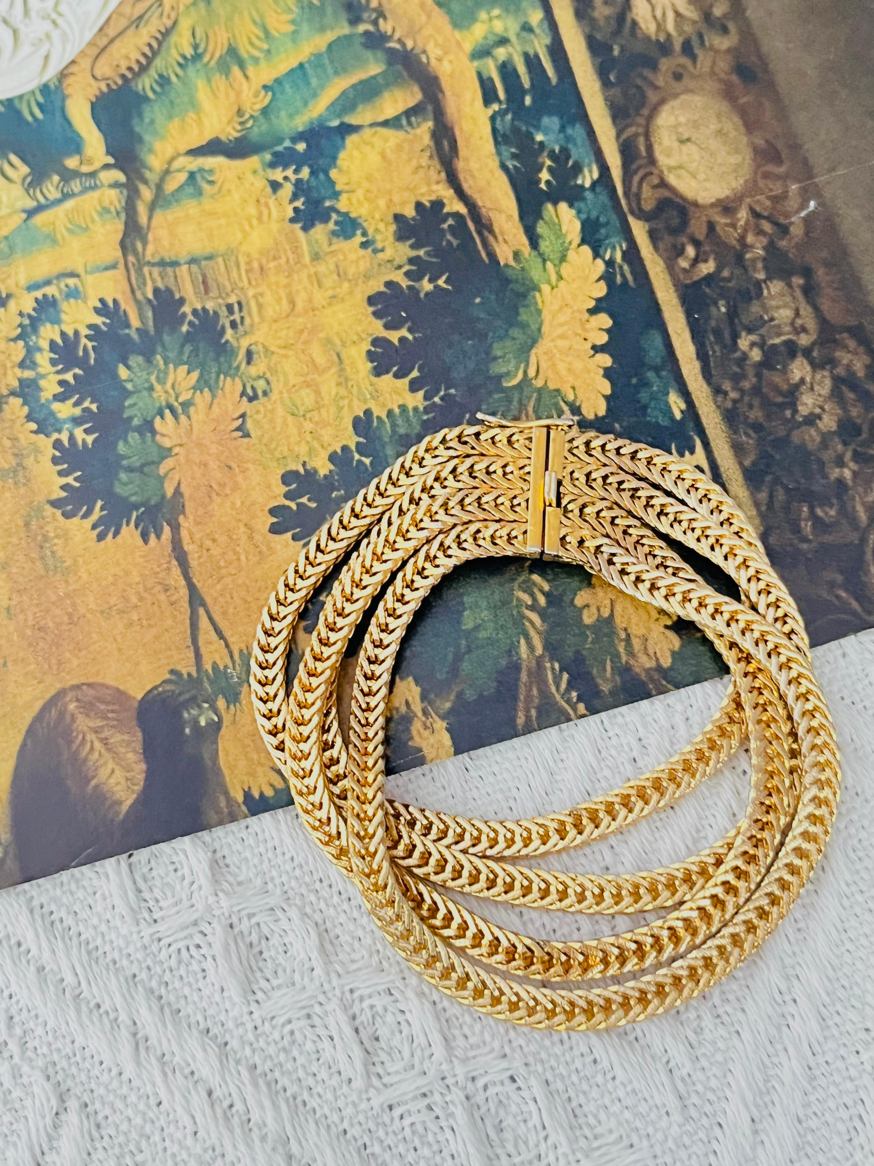 Christian Dior GROSSE 1963 Vintage Unisex Four 4 Strands Layers Wheat Chain Rope Snake Modernist Cuff Bracelet, Gold Tone

Very good condition. Light scratches or colour loss, barely noticeable. 100% Genuine.

Signed at the back. Very rare to find.
