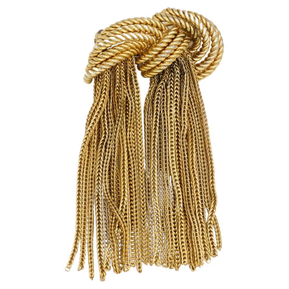 Christian Dior GROSSE 1965 Vintage Knot Bow Tie Double Tassel Rope Drop Chain Brooch, Gold Tone

Très bon état. Légères rayures ou perte de couleur, à peine perceptibles. 100% authentique.

Une pièce unique. Broche stylisée plaquée or. 

Fermeture
