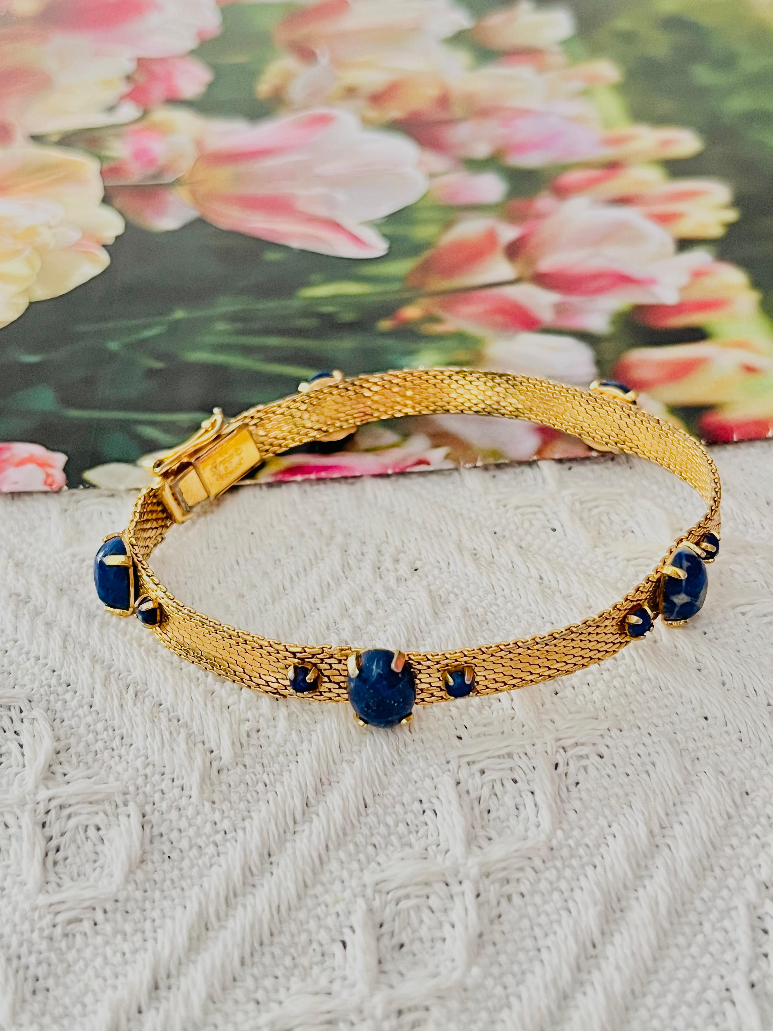 Christian Dior GROSSE 1967 Vintage Unisex Lapis Navy Blue Natural Stones Cabochon Oval Round Balls Mesh Woven Cuff Bangle Bracelet, Gold Tone

Very good condition. Light scratches or colour loss, barely noticeable. Not very flatted. 100%