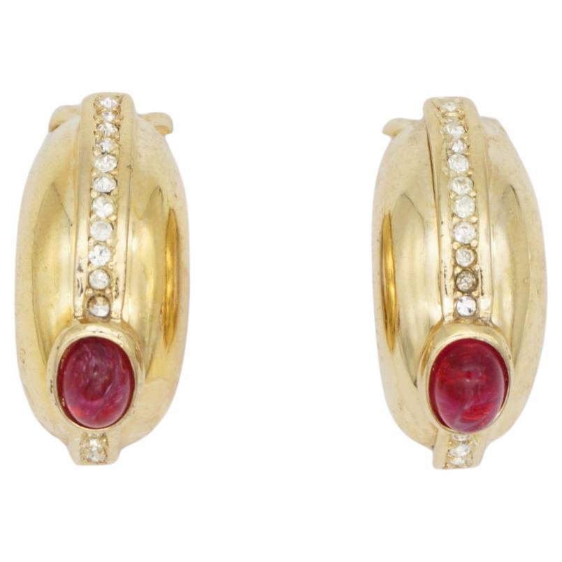 Christian Dior GROSSE 1970s Large Ruby Oval Crystals Half Hoop Dome Clip Earrings, Gold Tone

Very good condition. Light scratches or colour loss. Vintage and rare to find. 100% Genuine.

A very beautiful pair of clip on earrings, signed at the