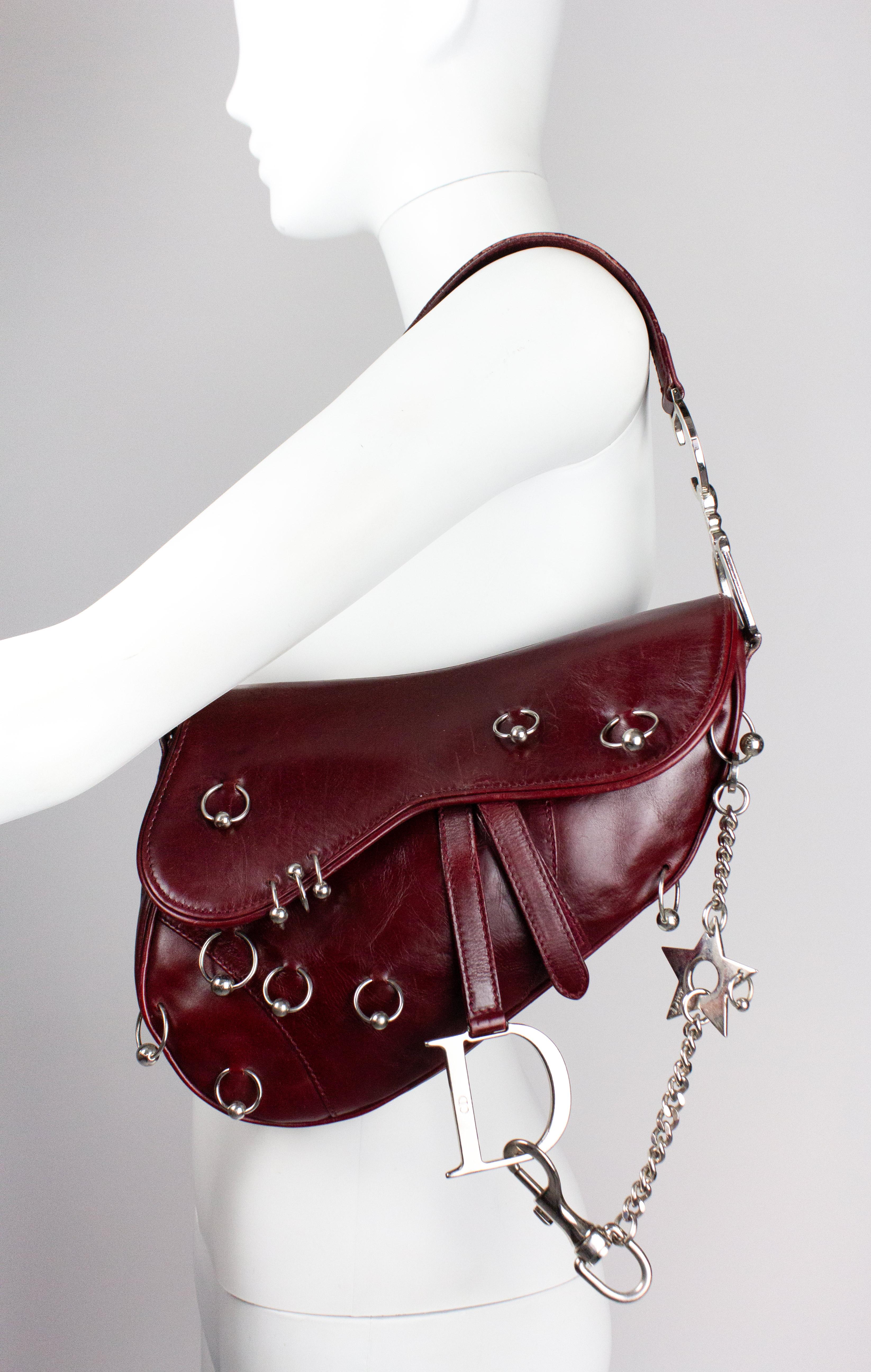 Rare vintage Christian Dior saddle bag, limited 'Hardcore' edition designed by John Galliano. As seen on Gisele Bündchen, who was photographed by Nick Knight wearing it for the Spring/Summer 2004 Dior campaign. Dark burgundy coloured leather with