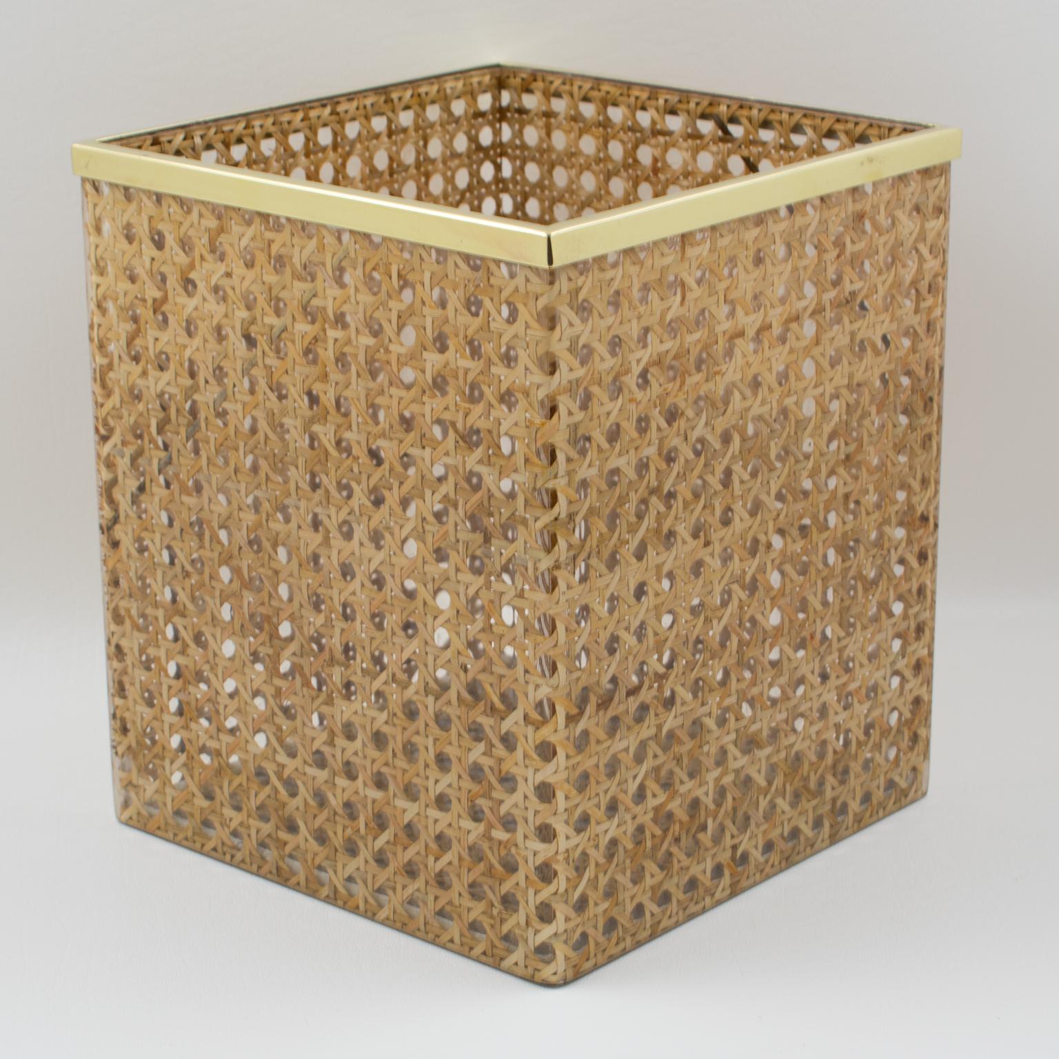 Lovely waste basket designed for Christian Dior Home Collection in 1970s. Geometric shape with brass gallery and real rattan canework embedded in the crystal clear Lucite. Great desk or home accessory for any modern interior.
Measurements: 7.69 in.