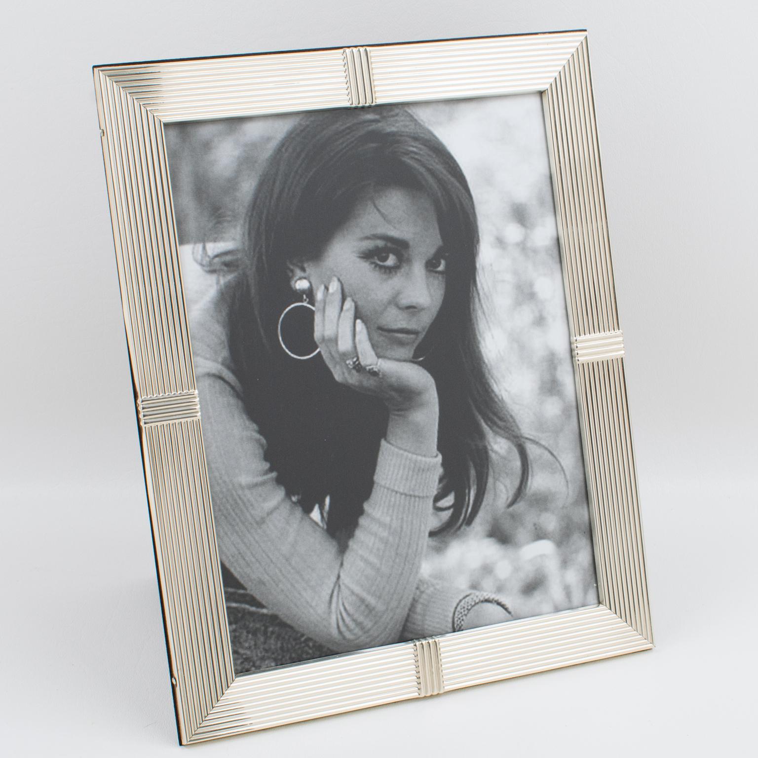 A stunning Christian Dior Paris sterling silver picture photo frame. Tall rectangular shape with striped patterns all around. The back and easel are in high gloss varnish dark wood. Marked on the edge with sterling silver legal hallmarks and a