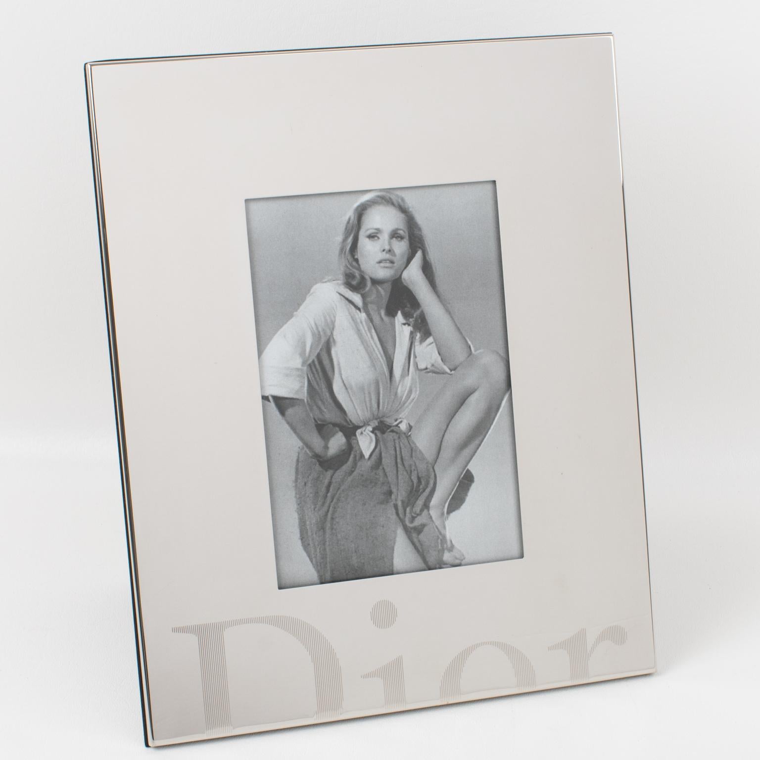 This gorgeous Christian Dior Paris silver plate picture frame was manufactured for the Dior Home Collection. The piece boasts a geometric plain shape with the 
