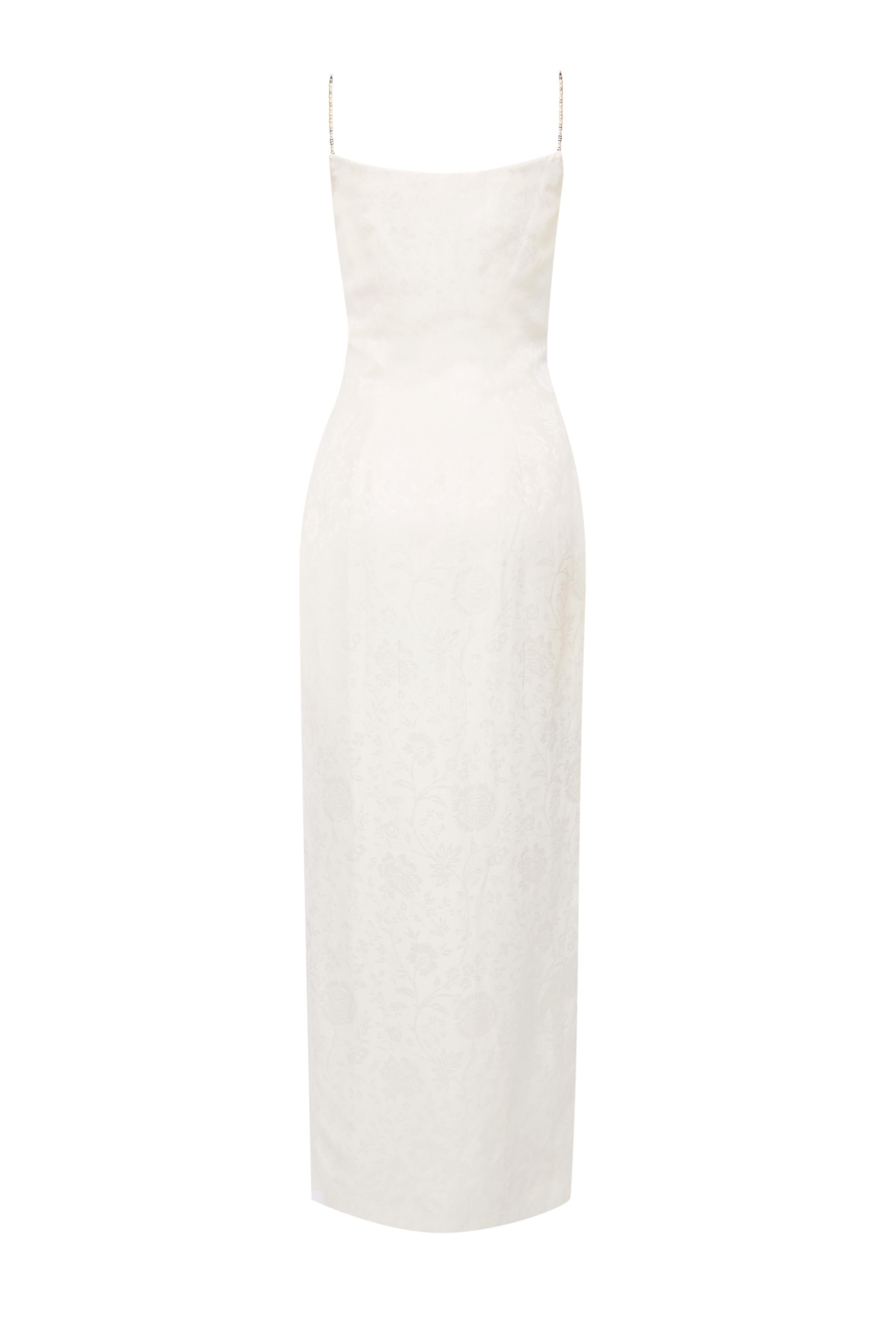 This rare Christian Dior dress, designed by John Galliano for the Spring/Summer 1998 collection, is a stunning example of the designer’s avant-garde creativity combined with Dior’s timeless elegance. 

Crafted in luxurious ivory jacquard, this gown