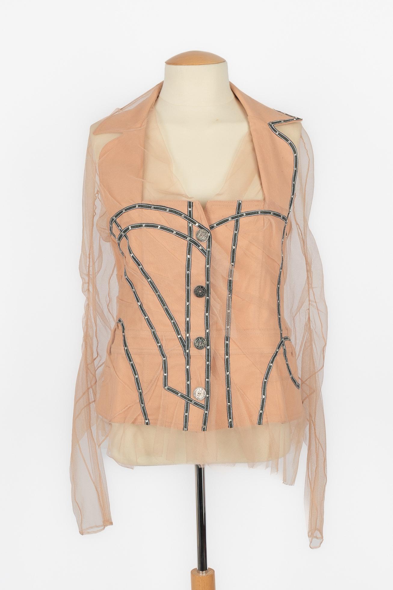 DIOR - (Made in France) Beige blended cotton and tulle jacket with black leather strips decorated with silvery studs. Size 40FR indicated. 2006 Spring-Summer Collection under the artistic direction of John Galliano.

Condition:
Very good