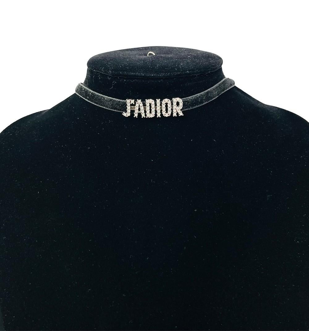 Christian Dior Velvet Crystal J’Adior Choker Necklace, Features a black velvet ribbon, Crystallized J'Dior Logo, and a hook closure. 

Total Length: 38.5 cm
Material: Velvet
Overall condition: Good, three missing crystals as shown in the