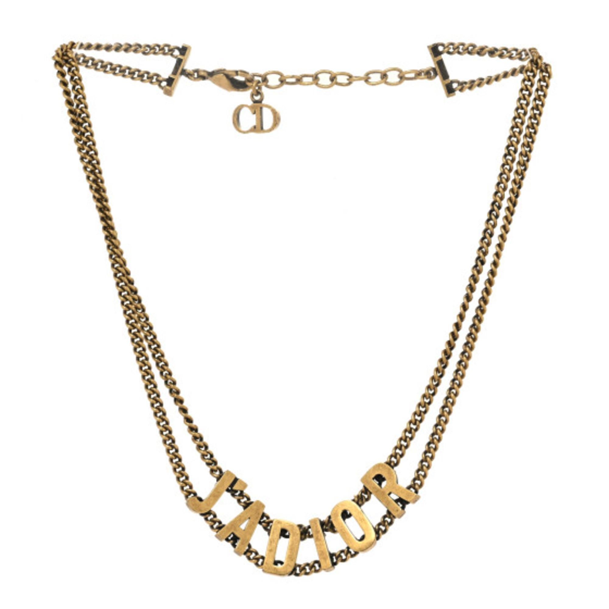 Elevate your accessory game with this Necklace in aged gold metal, a stunning choker from the renowned brand Christian Dior. Measuring 15 inches, this exquisite piece features the iconic J'ADIOR design, perfect for adding a touch of elegance to any