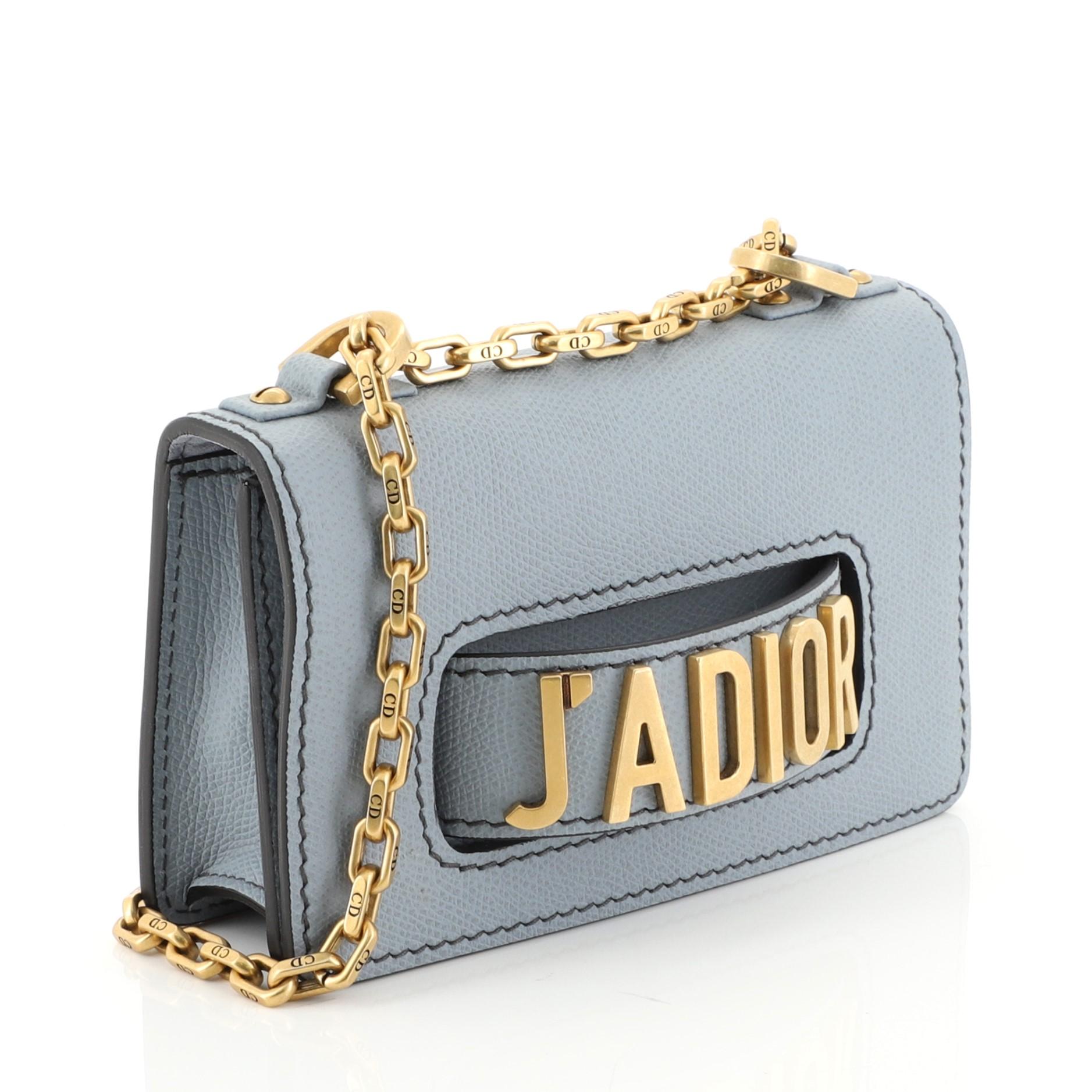 This Christian Dior J'adior Flap Bag Leather Mini, crafted from blue leather, features chain link strap, slot handclasp, and aged gold-tone hardware. Its flap opens to a blue suede interior with slip pocket. 

Estimated Retail Price: