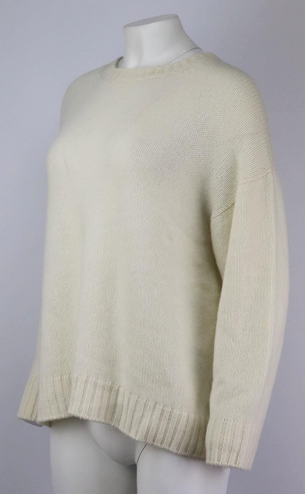 This ‘J’Adior 8’ sweater by Christian Dior is knitted from sumptuously soft ivory cashmere, this sweater has the brand’s motif on the back in black and ribbed trims. Ivory cashmere. Slips on. 100% Cashmere. Size: FR 42 (UK 14, US 10, IT 46). Bust