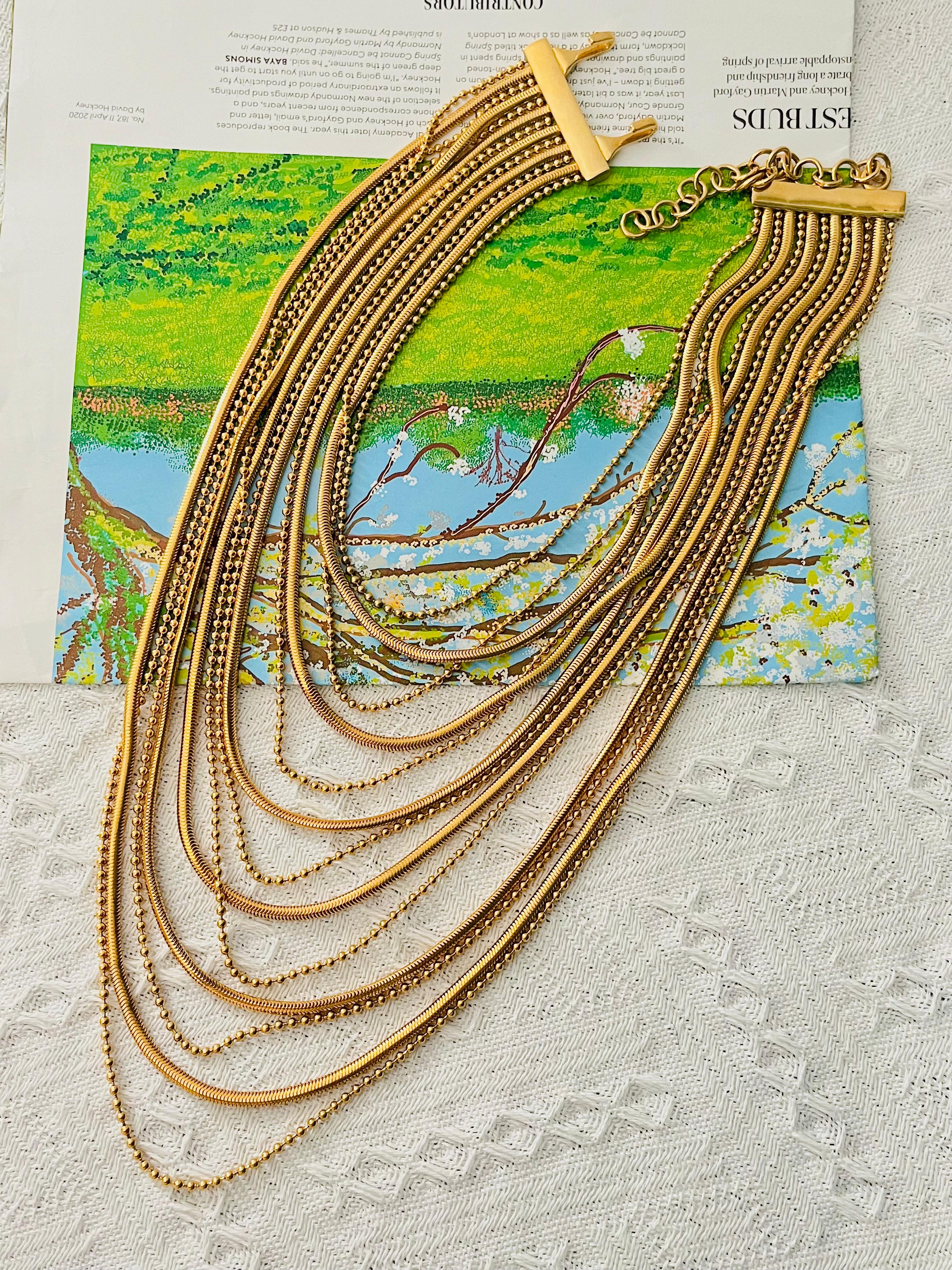 John Galliano for Christian Dior 1990s Unisex Luxury Masai Multi 13 Strands Snake Dots Small Ball Chunky Statement Long Necklace, Gold Tone

Condizioni eccellenti. 100% autentico. Molto raro da trovare.

Marchio 