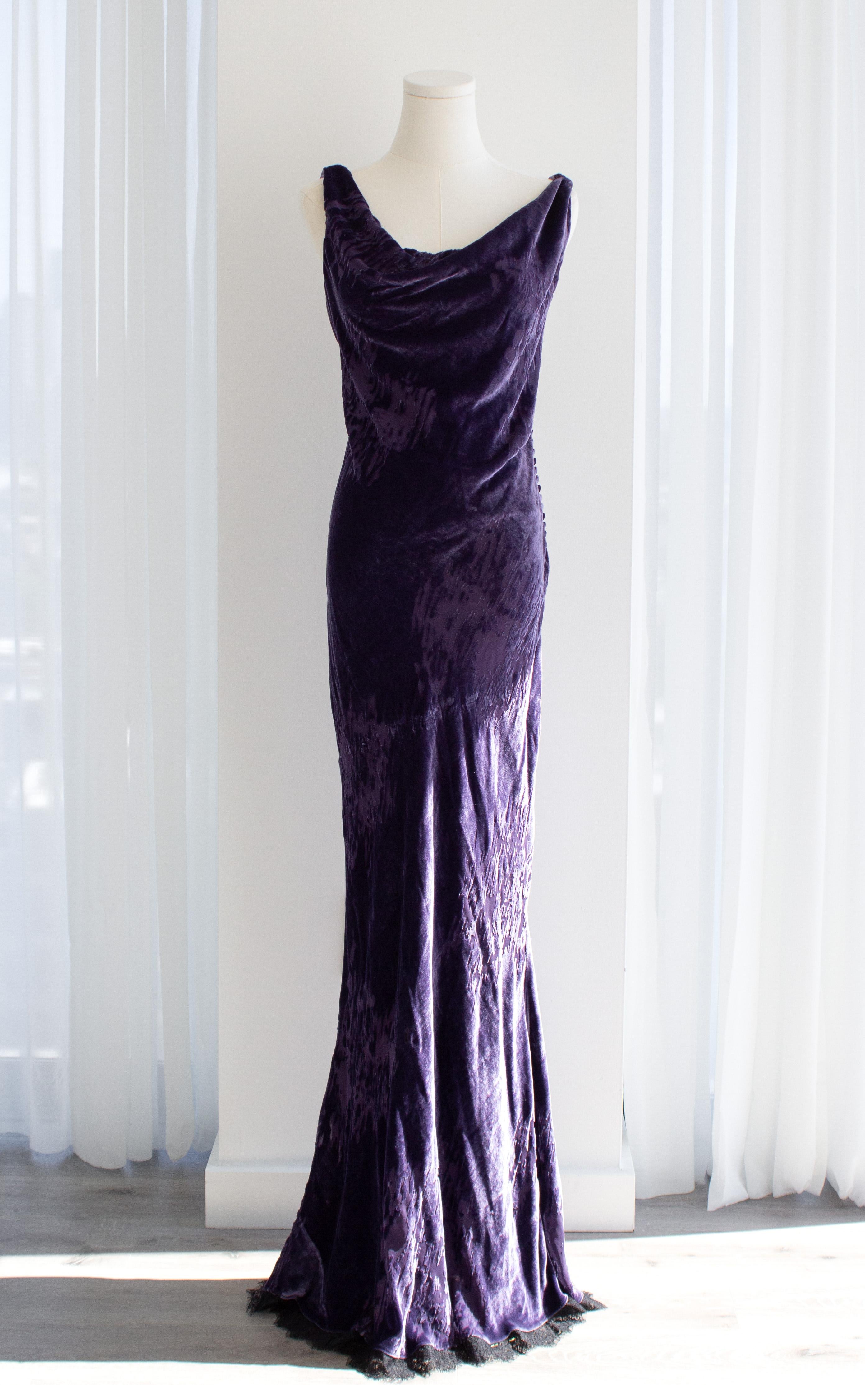 This Christian Dior evening gown by John Galliano, from the Autumn-Winter 2005-2006 ‘Off-Duty Icon’ collection, is crafted from a rich purple devoré velvet that captures the dramatic sensuality of Galliano’s vision for Dior. The dress features a