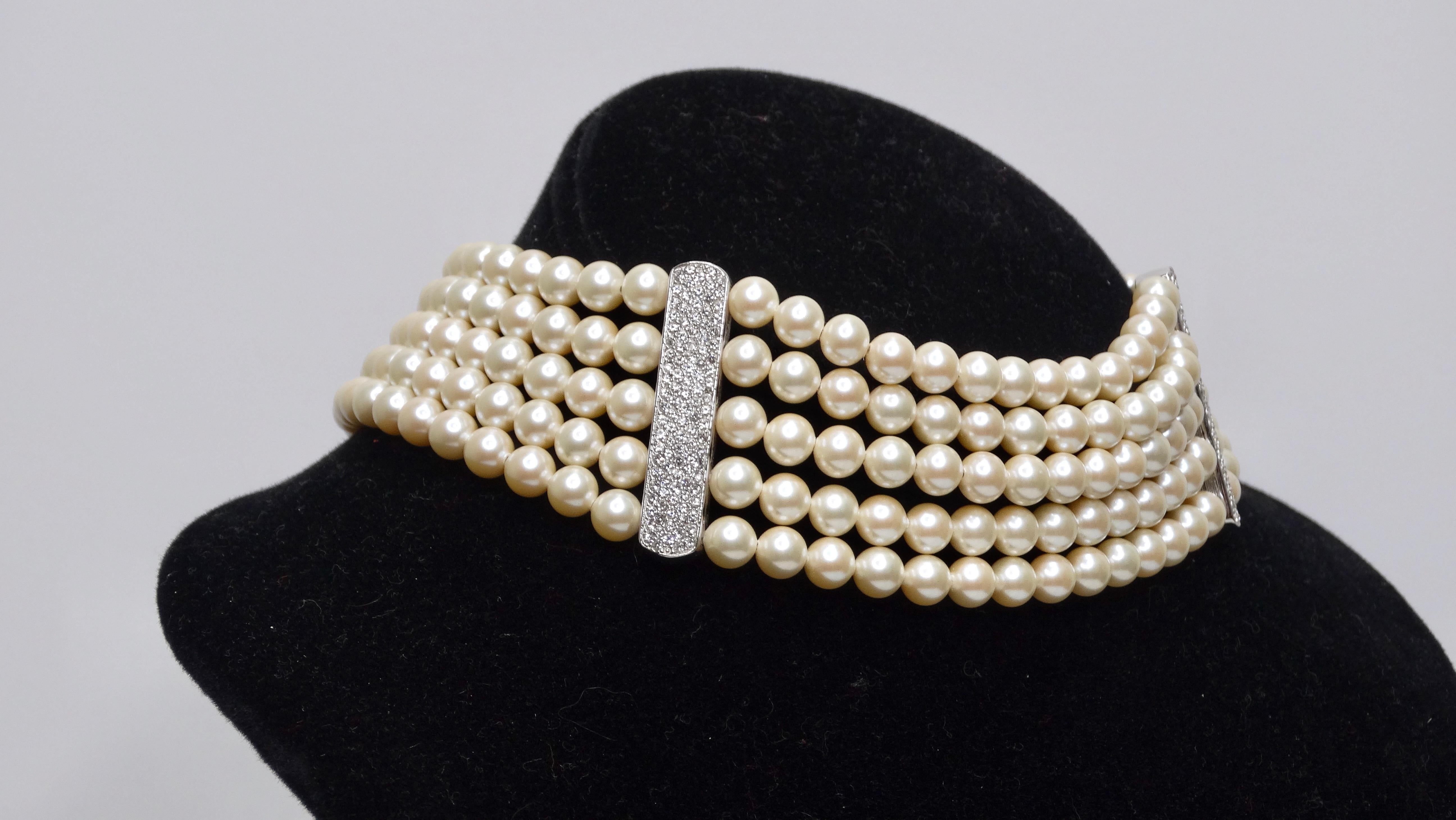 Look no further for your accessory for your next big event! This is a beautiful choker necklace has 5 rows of necklace beads, moulded soulpes elements, rhodium-plated and set with glass stones (crystal). In very good condition. There is a signature