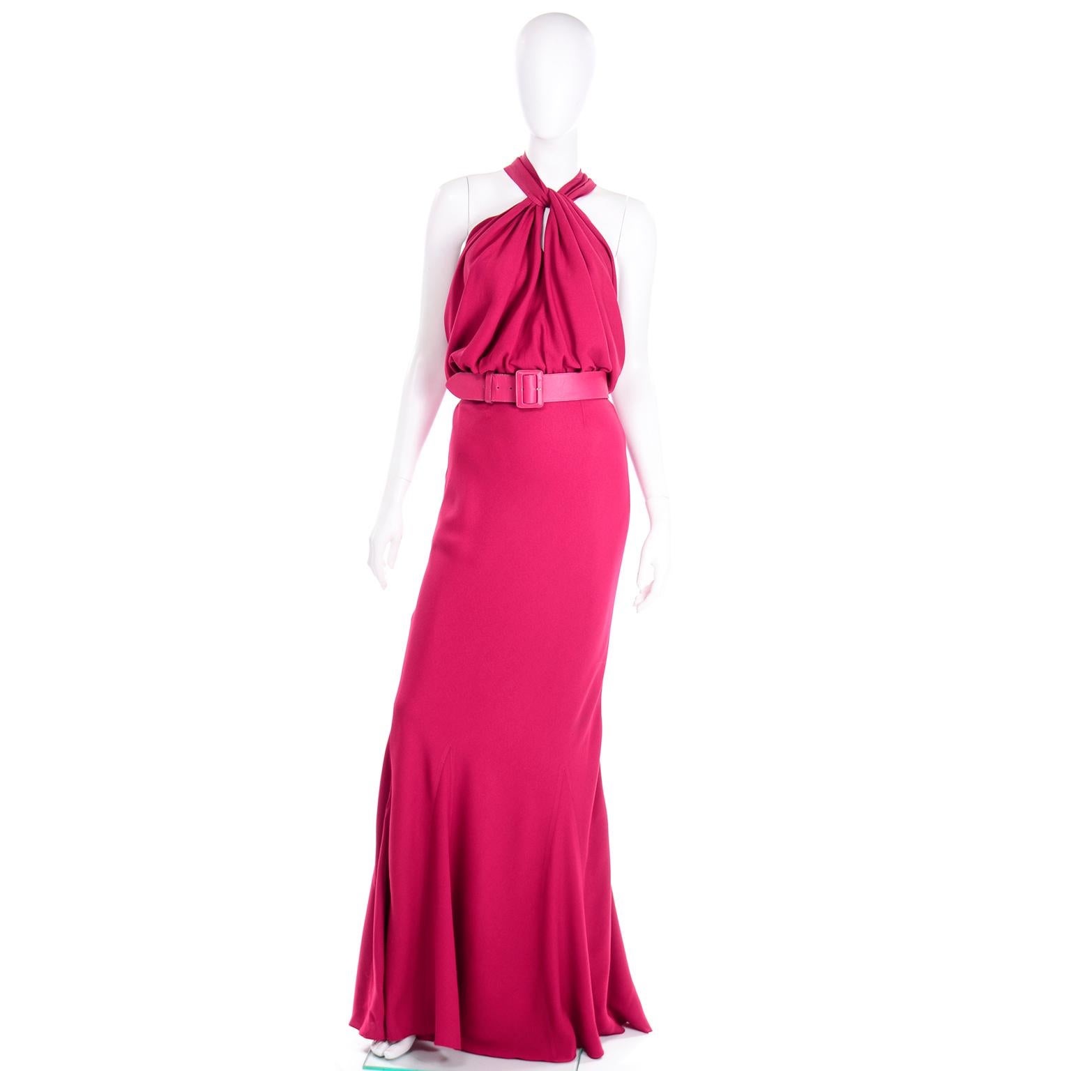 This incredible vintage 2009 John Galliano Christian Dior dress is in a stunning raspberry pink magenta crepe. This 1930's inspired dress is cut on the bias in a mermaid style silhouette. There are really unique zig zag seams along the hem of the