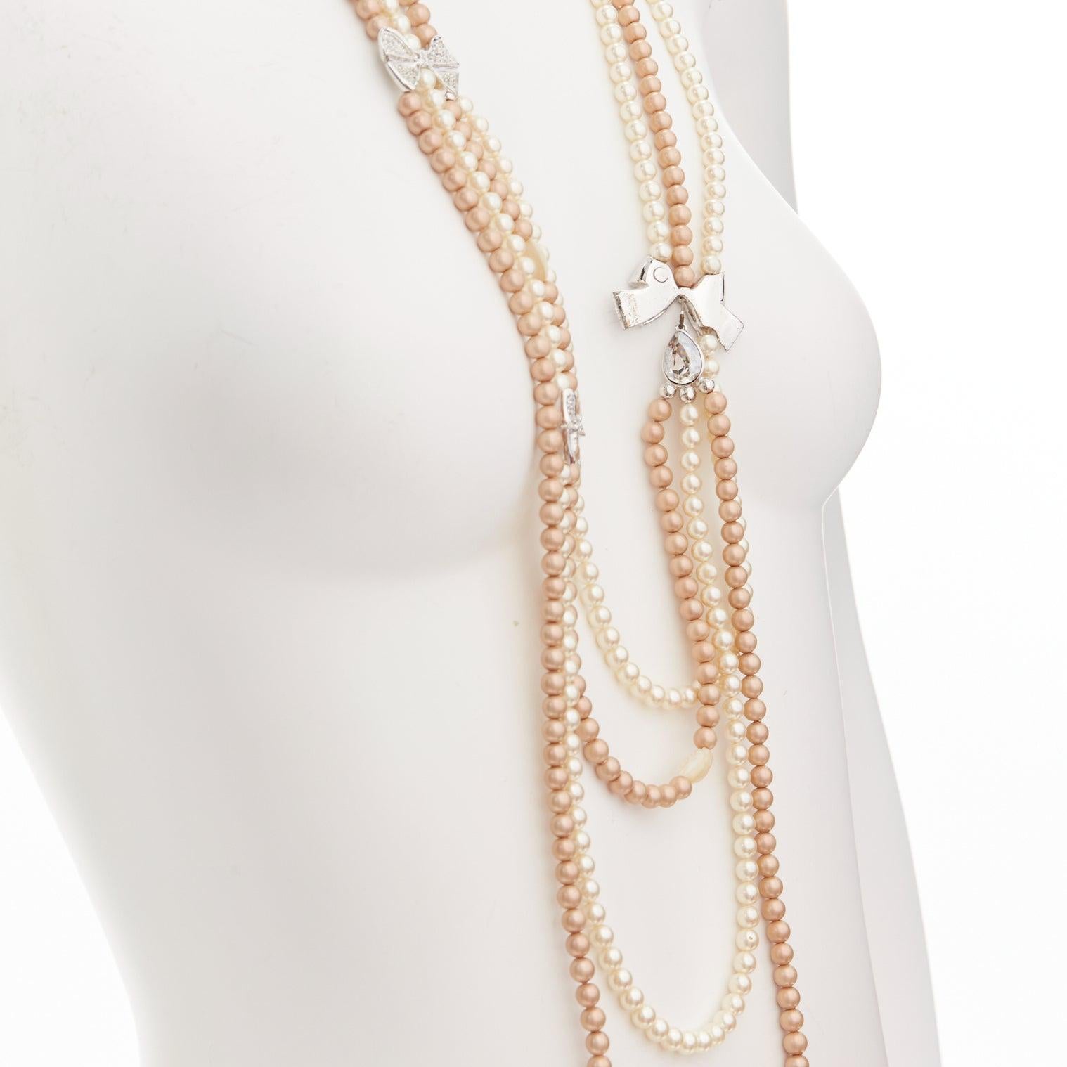 CHRISTIAN DIOR John Galliano Vintage silver crystal bow faux pearl long necklace
Reference: TGAS/D01024
Brand: Dior
Designer: John Galliano
Material: Faux Pearl, Metal
Color: Pearl, Silver
Pattern: Solid
Closure: Lobster Clasp
Extra Details: Silver
