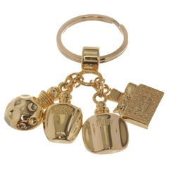 Christian Dior key chain with four pendants, gold-tone hardware.